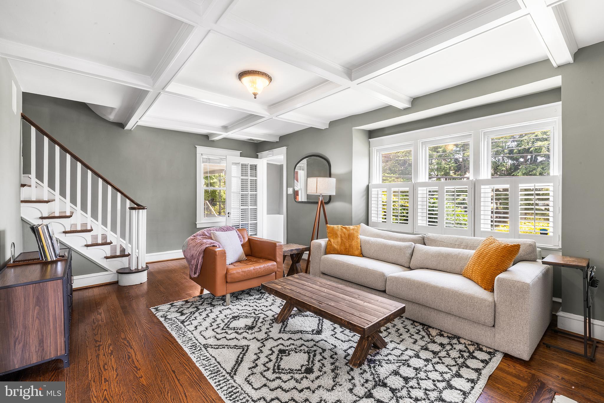 Situated on a leafy and manicured lot in Havertown’s prime Merwood Park neighborhood, 2404 Poplar Road is a classic Tudor home that charms with its timeless architecture, quality construction, and contemporary updates. Offering 3+ bedrooms, 2 full bathrooms, and multiple bonus spaces that can easily adapt to your lifestyle, this house has been designed to suit the varied needs of the homeowner. A charming vestibule welcomes you inside, where the main level unfolds with an inviting open layout. The living room showcases beautifully preserved oak hardwood floors, a coffered ceiling, a gas fireplace, custom built-ins, and a sun-filled bay window. Just beyond, the spacious dining room features matching hardwood flooring, another bay window, and French doors that open directly to the backyard. The expanded kitchen has been tastefully redesigned with white shaker cabinetry, stainless steel appliances, a breakfast bar and a gas cooktop, plus views overlooking the private, fenced backyard. Also on the first floor is a versatile bonus room currently used as a home office, equally suited as a den, playroom, or additional living space. The finished lower level provides even more flexibility; it makes for a great guest suite, recreation room, or home gym—and is complete with a tiled bathroom with a walk-in shower. The laundry and utility areas are neatly tucked behind closet doors that line the walls of the basement. Upstairs, the second floor houses two bedrooms and a full hallway bathroom. The sunny primary bedroom is made up of two original bedrooms that have been combined to create a generous bedroom with an impressive walk-in dressing room and closet tucked behind sliding barn doors. Should your needs change, the walk-in closet can easily be restored to an additional bedroom or even reconfigured to accommodate another full bathroom. A second bedroom, currently a nursery, and an elegant hall bath featuring timeless tile selections complete the level. The third floor adds even more possibilities with a spacious bedroom and an adjoining bonus room that could serve as a home office, walk-in closet, or future full bathroom. The property's layout easily supports a four-bedroom configuration while offering the potential to add additional bathrooms. Throughout the home, you'll find thoughtful custom details like specialty moldings, shiplap accents, coffered ceilings, and charming built-in nooks that add warmth and personality. Outdoor living is equally inviting, with a wooden deck accessed through the dining room's French doors, overlooking the beautifully landscaped backyard. Multiple entry points in and out of the home create exceptional functionality for everyday living and entertaining. Filled with natural light and overflowing with character, this remarkable Merwood Park residence offers the perfect combination of historic charm, modern comfort, and an unbeatable walkable location in the heart of Haverford Township. Enjoy the convenience of walking to neighborhood parks, the train, local shops, and restaurants, while also being just minutes from everything in Havertown and Ardmore! Disclaimer: Listing broker and licensees do not guarantee square footage or tax data. Certain photos have been virtually staged; the gas fireplace requires a repair in order to be used.  We look forward to your visit!