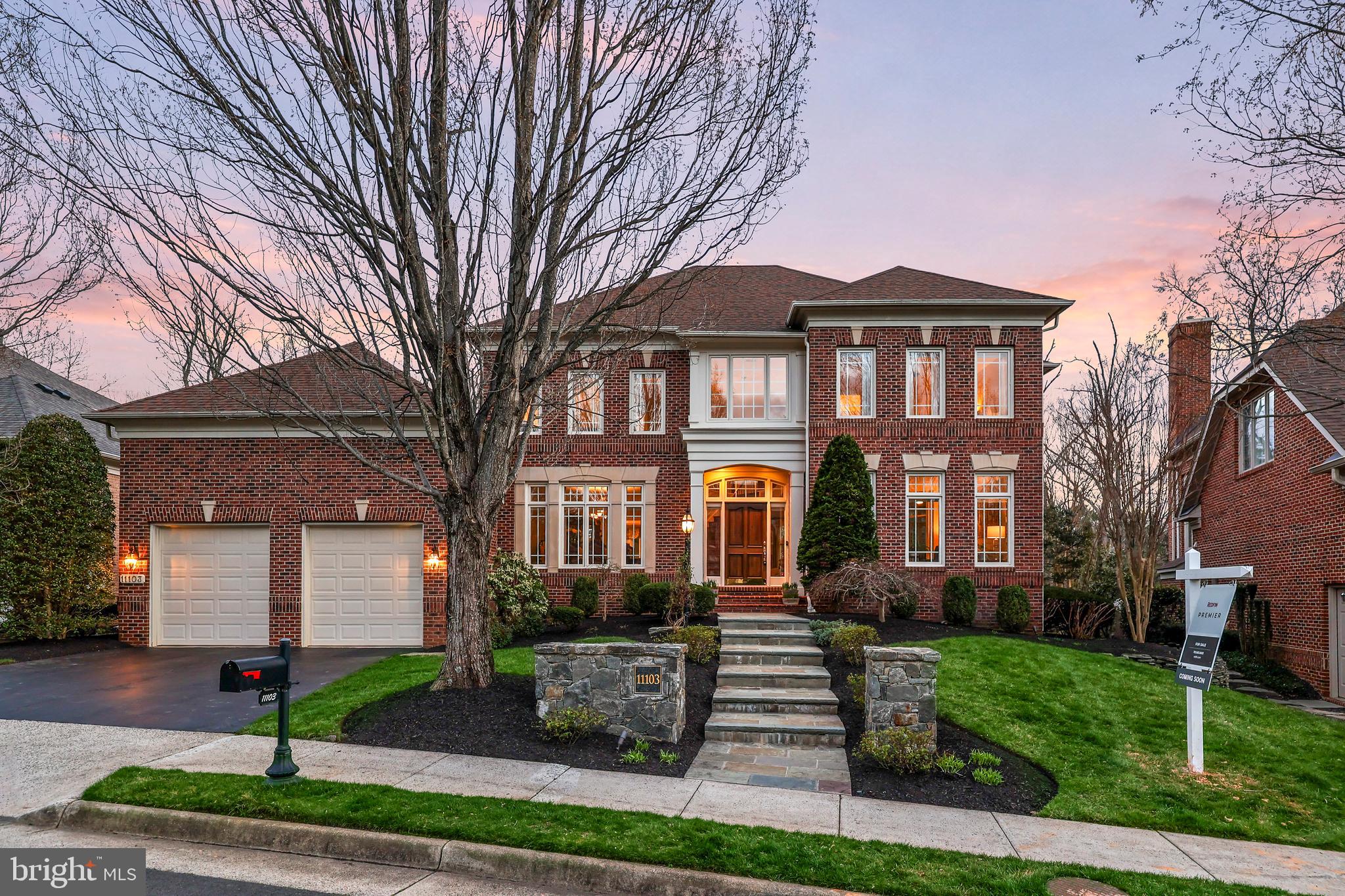 Discover an extraordinary and rare opportunity to own a masterfully crafted residence by the award-winning Gulick Group, a builder celebrated for inspired architecture, refined design, and a distinctive approach to luxury living for discerning homeowners. Perfectly sited on a lush homesite backing to trees within the prestigious enclave of One Cameron Place in Reston, this popular all-brick Randolph Colonial offers an exceptional blend of privacy, beauty, and convenience. With over $300,000 in thoughtful upgrades, this residence spans approximately 5,600 square feet across three finished levels, featuring five spacious bedrooms, four and a half baths, a two-car garage, and a patio designed for comfortable everyday living. Recent enhancements include a new roof (2022), updated HVAC systems (2023), a new hot water heater (2024), a refinished garage with new interior lighting (2025), new washer (2026), and extensive window replacements completed (2020 and 2023-roughly 65% windows). Additional updates include a remodeled primary bath (2023), a renovated Jack-and-Jill bath (2024), and an updated main-level powder room (2022), along with many other fine improvements throughout the home. A grand two-story foyer welcomes you with elegant moldings, gleaming hardwood floors, and a sweeping curved staircase with updated iron balusters that sets the tone for the refined interiors beyond. Formal living and dining rooms exude sophistication with designer finishes and custom drapery, creating an ideal setting for both intimate gatherings and formal entertaining. French doors lead to a private home office enhanced by a gas fireplace, abundant natural light, and plantation shutters, offering a serene and inspiring workspace. At the heart of the home, the expansive family room showcases a dramatic wall of Palladian windows with rich hardwood flooring, custom built-ins, and a second gas fireplace, creating an inviting and comfortable gathering space for everyday living. The fully remodeled gourmet kitchen is a chef’s dream, appointed with exotic granite countertops, custom cabinetry with soft-close features, and premium Jenn-Air appliances. The adjoining sunroom, complete with a built-in bench, provides the perfect setting for casual dining and morning coffee while overlooking the private backyard. There is also a lovely patio offering an ideal space for family and friends to relax and spend time. Upstairs, the gracefully curved staircase with updated iron balusters leads to a beautifully refreshed bedroom level, featuring hardwood flooring in the hallway and plush new carpet (2024) in all bedrooms. The luxurious primary suite offers a tray ceiling, elegant moldings, and dual custom walk-in closets designed for optimal organization. The spa-inspired primary bath, renovated (2023), offers a frameless glass shower, floor-to-ceiling tile, a freestanding soaking tub, expansive double quartz vanities, and a private water closet. A secondary bedroom suite enjoys its own full bath, while two additional bedrooms share a beautifully renovated Jack-and-Jill bath (2024) with modern finishes. The walk-up lower level is equally impressive, offering versatile spaces designed for both relaxation and entertainment with recessed lighting, including a spacious recreation room, private gym with mirrored walls, custom wet bar with glass-front cabinetry, wine cellar, media area, flexible bonus space, and a fifth bedroom with a full bath, ideal for guests. Enjoy easy access to trails, Lake Anne, Lake Newport Park, Reston Town Center, Silver Line Metro, Tysons Galleria, Wolf Trap, and Dulles Airport, all just minutes away. Meticulously maintained and thoughtfully upgraded from the rich materials to the carefully selected fixtures and lighting, this home of such caliber offers exceptional comfort, timeless elegance, and a rare opportunity to own a Gulick masterpiece in one of Reston’s most sought-after communities.