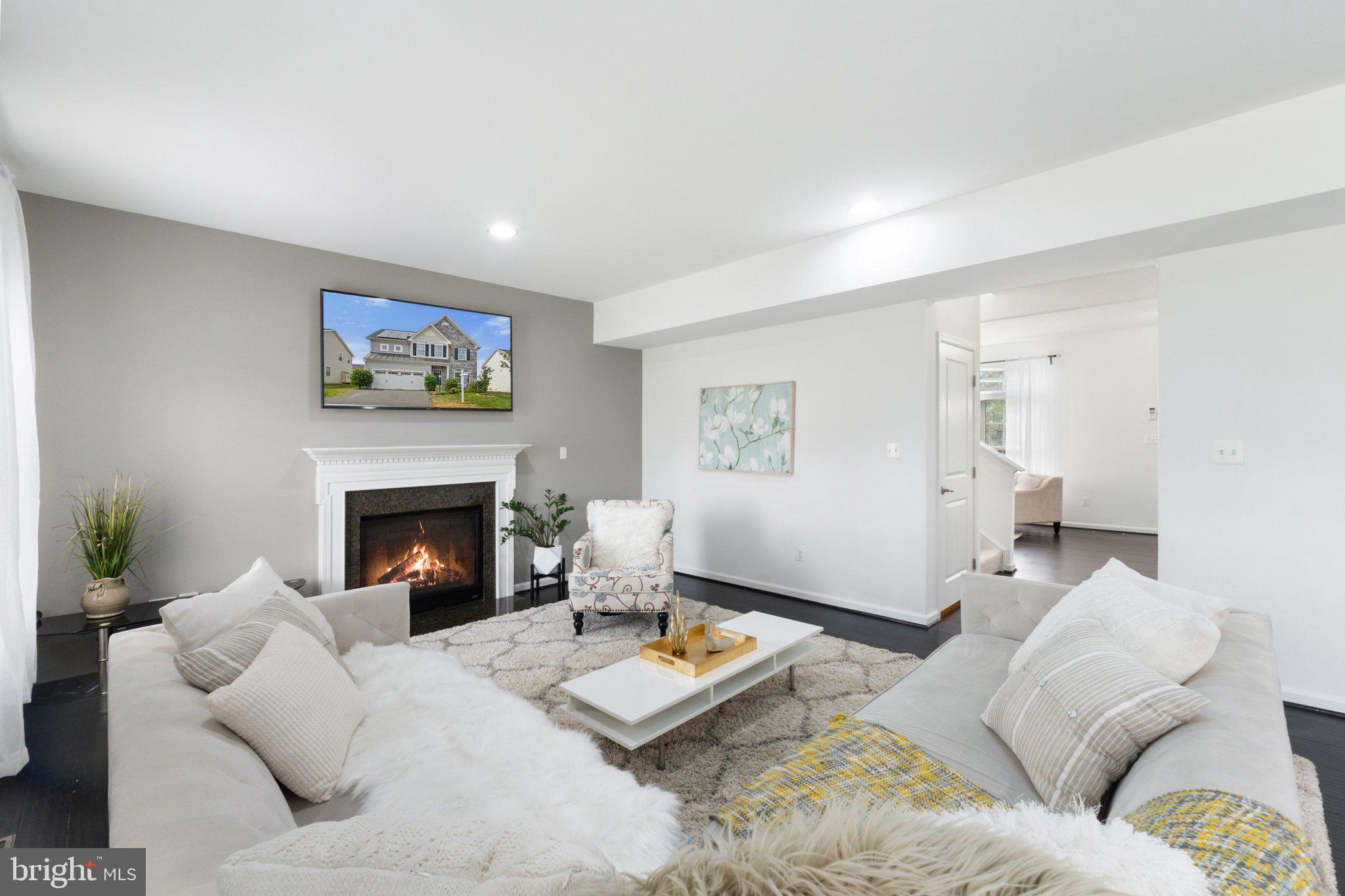 This stunning Venice model home by Ryan Homes features brand-new 9-inch luxury floor planks that add a touch of elegance and sophistication on the main level. Additionally, the property boasts fully paid-off solar panels that efficiently power the entire house, ensuring that your electric bill remains exceptionally low—no more than $30 a month. This spacious home offers 3,425 square feet of living space, five bedrooms, and three and a half baths, making it perfect for families of all sizes. As you enter, you'll be greeted by a comfy and inviting sitting room, setting a warm tone for the rest of the home. The open floor plan seamlessly integrates the kitchen, dining room, and huge family room with a fireplace. The main floor also provides access to a patio and a spacious backyard, a two-car garage, and a fully finished basement with a bedroom, full bath, and walk-up stairs leading to the backyard. Plus, it's rough-in ready for a bar or a second laundry room, making it a versatile and modern living space.