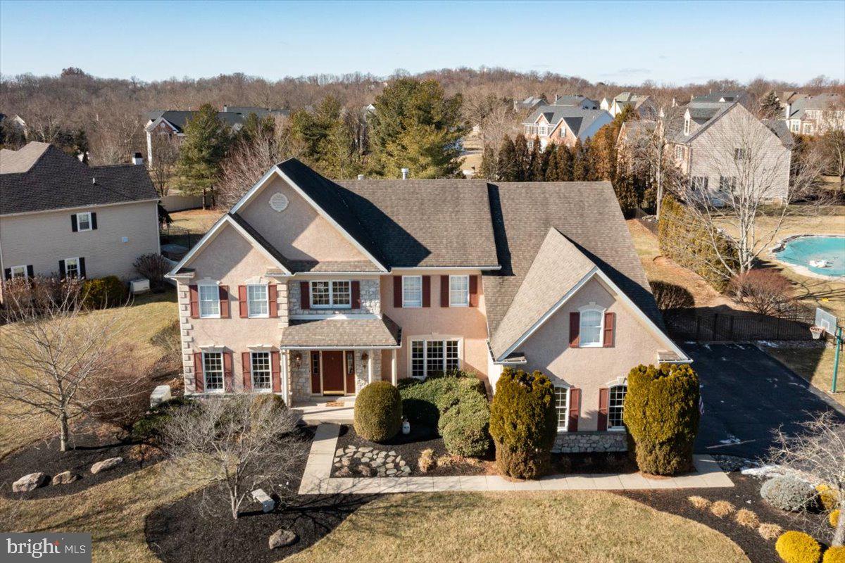 Back on market with new roof, new pool liner, new furnace, new hot water heater, & more! Welcome to 65 Bittersweet Drive, nestled in the highly sought-after Doylestown Lea community, within the award-winning Central Bucks School District. This stunning home offers 4 bedrooms, 3.1 bathrooms, and plenty of space for both relaxing and entertaining. As soon as you step into the grand two-story foyer, you'll be greeted by freshly refinished hardwood floors and an abundance of natural light, creating a warm, inviting atmosphere. To the left, the formal living room offers timeless elegance, and to the right, the chic dining room, with crown molding and chair rail, is perfect for hosting holiday feasts. The newly updated gourmet kitchen boasts granite countertops, a subway tile backsplash, rich cabinetry, an oversized center island, and a sunny breakfast area with custom-built bench seating. The adjacent two-story great room is ideal for game nights or large gatherings, complete with surround sound and a stunning floor-to-ceiling stone gas fireplace framed by large windows. Double doors lead to a spacious office with serene views of the fully fenced backyard. From the kitchen and laundry room, patio doors offer easy access to a backyard oasis, featuring an in-ground pool, large hot tub, and lush landscaping. Enjoy outdoor dining, entertaining, or relaxing in nature year-round from the custom paver patio. The first floor also includes a laundry room and powder room. The grand split staircase leads you up to the luxurious primary suite, with two walk-in closets and a cozy sitting area. The en-suite bath includes dual vanities, a soaking tub, a large stall shower, and a private water closet. Down the hallway that overlooks the great room, two additional spacious bedrooms share a beautifully appointed Jack and Jill bathroom, while the fourth bedroom enjoys its own private en-suite bathroom. The finished basement offers flexible living space, including an electric fireplace and a kitchenette – perfect for movie nights or hosting guests. Ample storage exists in both the unfinished portion of the basement and the expansive three-car garage. The whole-house Generac generator and exterior drainage system offer added peace of mind for years to come. Located just a short walk to Central Park, scenic trails, Terrain at DelVal, and the soon-to-be-completed Doylestown Township Park Improvement Project, this home offers unparalleled access to comfort and convenience. Don’t miss the chance to make this your dream home—schedule your private showing today and experience the exceptional lifestyle waiting for you in the Lea!