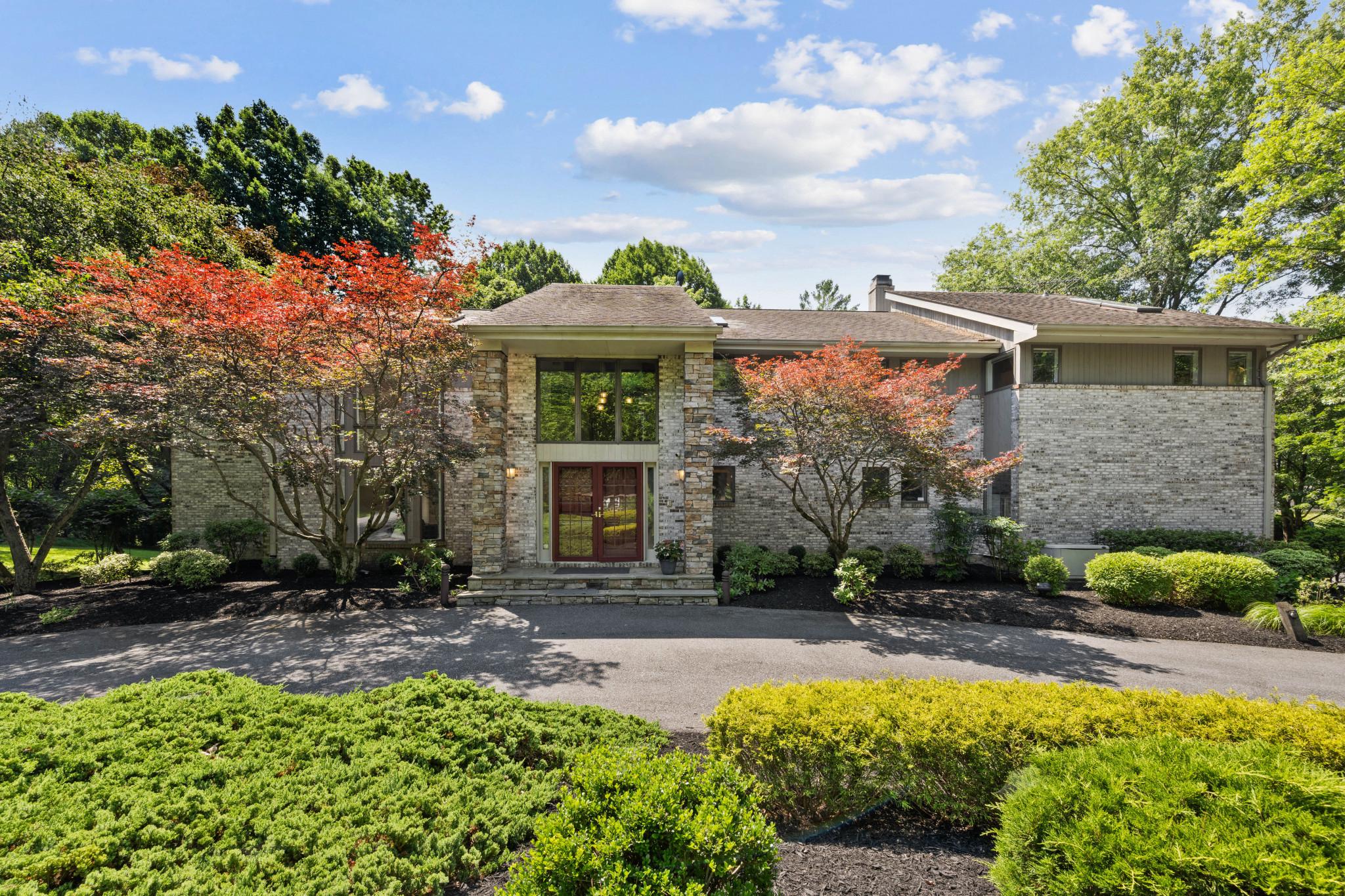 Tucked away at the end of a quiet cul-de-sac in one of Columbia's most distinctive neighborhoods, this exceptional contemporary residence offers 7,635 finished square feet of thoughtfully-designed space blending architectural character, expansive living, and serene privacy. Cherished by its original owners, this home reflects decades of pride in ownership while offering an extraordinary opportunity for its next chapter. //  Set on a spacious private homesite backing to mature woodland, the property feels worlds away while remaining just minutes from the best of Howard County. Stone monuments introduce the property, adding a refined approach to the gorgeous setting. A circular driveway brings you to the residence, as extensive hardscaping, wooded views, multiple outdoor entertaining areas, and beautifully landscaped grounds create an atmosphere of quiet retreat rarely found in Columbia like this.  //  

Designed around light, volume, and connection to nature, the home unfolds through soaring ceilings, dramatic walls of glass, and expansive living spaces that invite both grand entertaining and comfortable everyday living. From the 2-story foyer to the upper hall, every space is thoughtfully designed to maximize openness, natural light, and views of the surrounding landscape. At the heart of the home is a huge gourmet kitchen featuring custom cabinetry, generous granite workspaces, stainless steel appliances, a breakfast nook, and an oversized center island. A dramatic living room defined by soaring vaulted ceilings and abundant natural light leads seamlessly into a formal dining room. Just beyond, the music room showcases a breathtaking two-story bay window and skylights, filling the space with natural light and providing the perfect setting for a grand piano, lush greenery, a reading nook, or an inspiring home studio. The family room features its own vaulted ceiling, a floor-to-ceiling stone gas fireplace, and access to the sunroom. A private study, laundry room, full bath, and half bath complete this level.  //  The large deck functions as an outdoor extension of the interior—perfect for effortless entertaining, al fresco dining, or simply enjoying the peaceful wooded surroundings. Below, the bluestone patio provides a second destination for gathering to enjoy the outdoors throughout the day and into the evening. // 

Occupying its own wing, the impressive owner’s suite serves as a luxurious retreat, curated with generous proportions and exceptional amenities. The spacious bedroom is complemented by a dedicated sitting room, custom dressing room, oversized walk-in closet, and a beautifully-renovated spa-inspired bath featuring dual vanities, a freestanding soaking tub, and an oversized walk-in shower. Also on this level are three additional bedrooms, two additional full bathrooms, a walk-in hall closet, and a huge loft with a built-in desk workstation. One of the bedrooms is a suite with a private attached bath. // The walk-out lower level presents exceptional flexibility with a large recreation room with brick wood burning fireplace and a walkout to the patio, a full kitchen, a bonus room, two bedrooms, full and half baths, and endless possibilities for multigenerational living, extended guest accommodations, an au pair suite, or a private work-from-home environment. // 

La Isla is an intimate and sought-after community prized for its distinctive architecture, mature trees, quiet streets, walking paths, and the added benefit of no HOA fees. This central Columbia location is ideal for commuters and is close to wherever you want to be—just minutes from premier shopping, dining, parks, commuter routes, Old Ellicott City, and more.

// For those seeking a residence far beyond the ordinary, welcome to 6614 Corina Court. Where architectural design, privacy, and everyday luxury come together in one rare offering. //