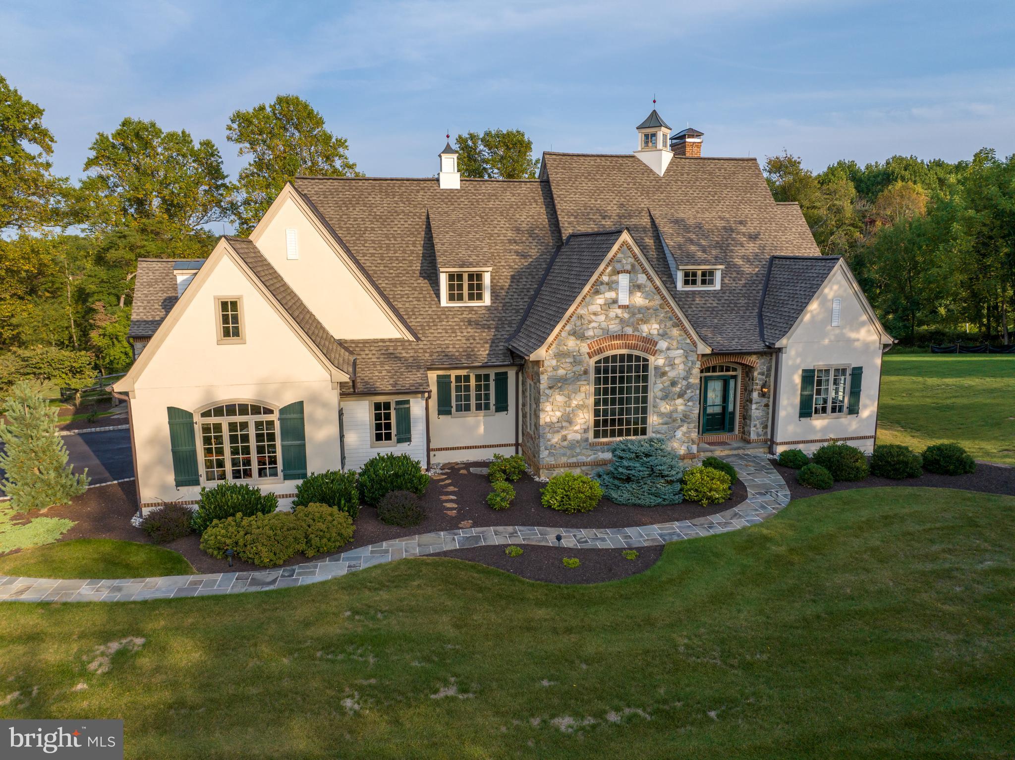 Buyer change in circumstance means this GORGEOUS HOME is now available for you! Majestic, Charming, Elevated and Bespoke all define this home in the highly sought after community of Saddle Ridge. The majestic views from this home go for miles as you are sitting at one of the highest points in Lower Saucon.  Built by Blair Custom Homes, with meticulous attention to detail and craftsmanship, this home is very unique in many ways. The main floor features not only a Primary Suite but a full guest suite with it's own full bath AND access to the screened in porch overlooking the private yard. The great room with it's wall of windows, custom fireplace, built in cabinetry and access to the kitchen face the private treelined 2.91 acre lot. The kitchen features warm, high quality cabinets with equally impressive appliances. The dining room features a soaring 2 story ceiling with a palatial window and ample space for even the largest dinner party. Upstairs features a wide hall/study space perfect for video games or quiet reading in a comfy chair. 2 bedrooms on this level share a full bath with privacy and additional attic space may be able to be finished if more space is needed. The lower level features an office space and gym with ample storage and access to the custom garage with epoxy flooring. This home has so many bespoke details you may fall in love instantly. Saddle Ridge is one of the areas most sought after communities for it's nature, rolling hills and proximity to everything one needs. Don't be surprised to have a family of deer as your neighbors.