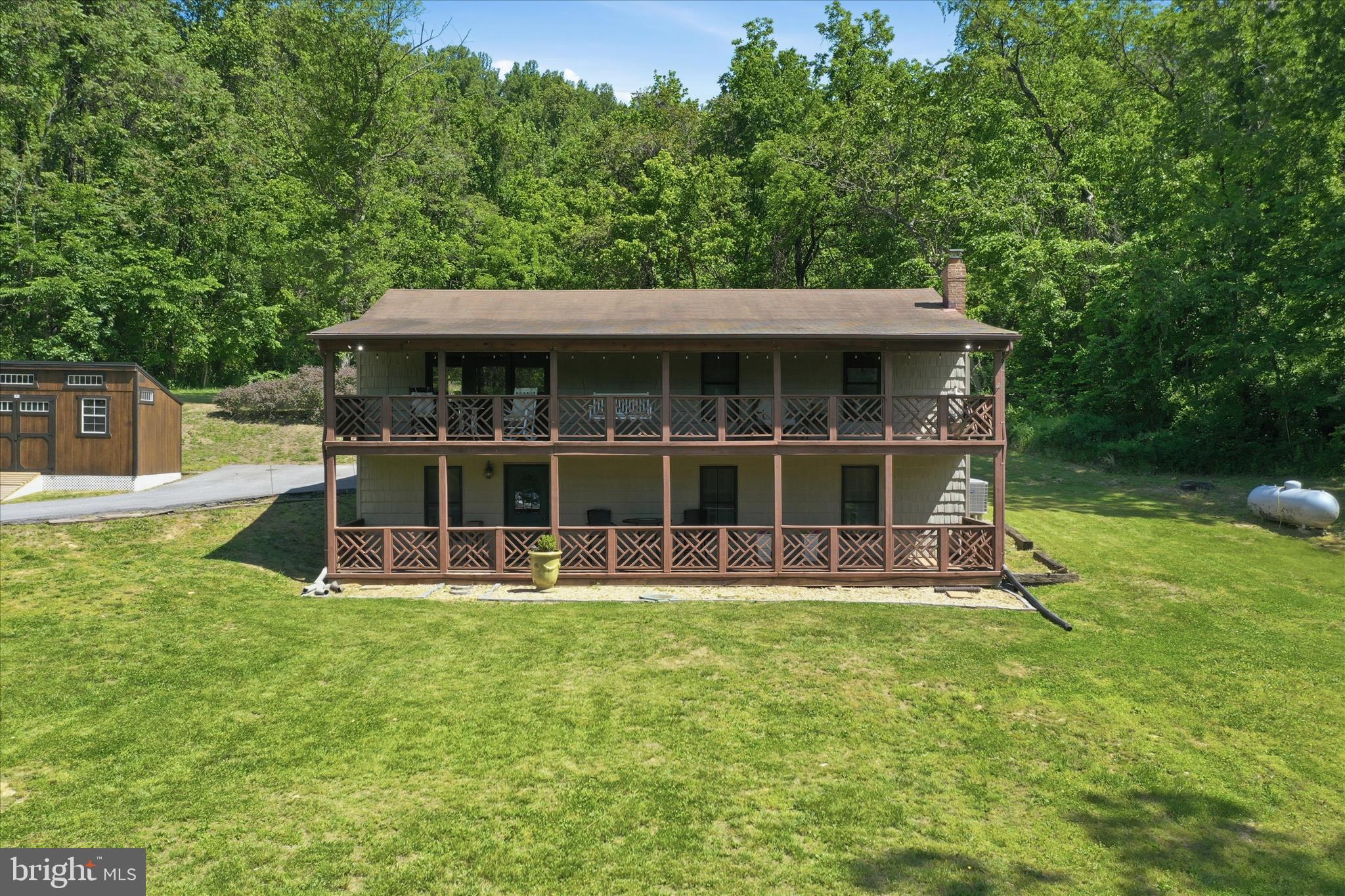 Peaceful country living on a private ¾-acre lot, tucked away in a serene setting yet conveniently located near I-66 for an easy commute. Enjoy the best of both worlds with nearby nature trails, wineries, and endless outdoor recreation just minutes away.
This charming cabin-style home is full of rustic character and warmth throughout. The main level features an open floor plan with hardwood floors and vaulted ceilings, creating a bright and inviting living space. You’ll also find 3 bedrooms and 2 full bathrooms on the main level.
The finished lower level offers abundant additional living space, including a cozy den with a wood stove, an additional bedroom, full bathroom, laundry area, and plenty of storage.
Take in beautiful views of rolling hills and lush greenery from the two-level deck, perfect for relaxing or entertaining. Recent updates include new kitchen appliances, light fixtures, recessed lighting, interior paint,  and new shed. Also included with the home is a Generac whole-house Generator.