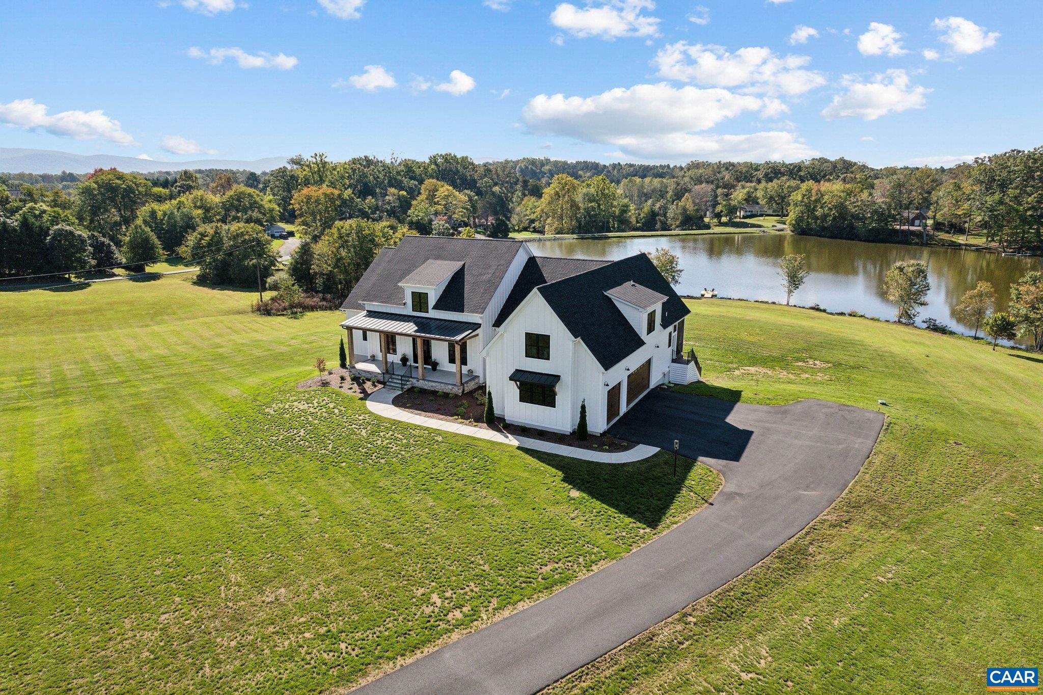 Captivating lakefront custom-built residence on 5.97 acres in Albemarle County. Completed in 2023, this turn-key home exudes luxury from top to bottom, showcasing designer appointments throughout. Its contemporary style beautifully complements the stunning water views visible from each & every picture window. Enjoy expansive lake vistas and your own private dock for relaxing afternoons or evenings. The sought after open floor plan features 10' ceilings, creating an unparalleled atmosphere for beauty, comfort, and entertaining. Main level includes two elegant bedroom suites, a dedicated home office, and a convenient third suite on the second level. The chef's kitchen is a remarkable centerpiece: high-end stainless steel appliances, oversized island with seating, custom cabinetry, & quartz countertops. A bright and inviting breakfast area seamlessly flows into the kitchen, perfect for casual dining and the enormous custom walk-in pantry is a showstopper. The walkout terrace level is equally impressive, featuring two additional bedrooms, sunny gathering room, kitchen & a full bath?each with marvelous lakefront views. This residence is not just a home; it's a serene retreat, designed for those who appreciate the finer things in life.,Quartz Counter,Wood Cabinets,Fireplace in Great Room