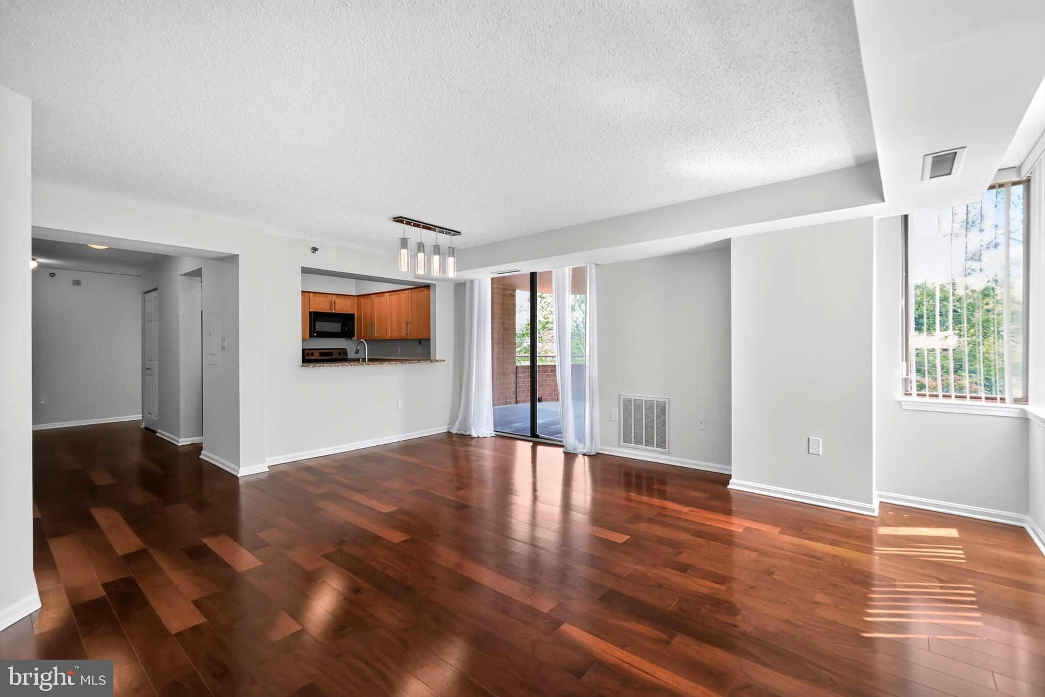Big, Bright & Beautiful! This Move-in ready well maintained 2 Bedroom / 2 Bathroom condominium features a kitchen with a Breakfast Bar and granite countertops!  Beautiful new flooring in both bedrooms and the entire home has been freshly painted. At over 1,300 Sq, Ft., you will have plenty of room to entertain and enjoy!  This condominium also features 2 assigned indoor parking spaces, a Washer/Dryer, a sliding door in the living room that opens to a  large private balcony.  The community also features an outdoor pool, tennis courts & walking paths. This pet-friendly home is perfectly located on a quiet street a short walk from the Grosvenor Park Metro Station.  It's also close to I-495, I-270 & Rockville Pike.  Shopping and Dining in Downtown Bethesda is just a short Metro ride away.  This is care-free living at it's best!