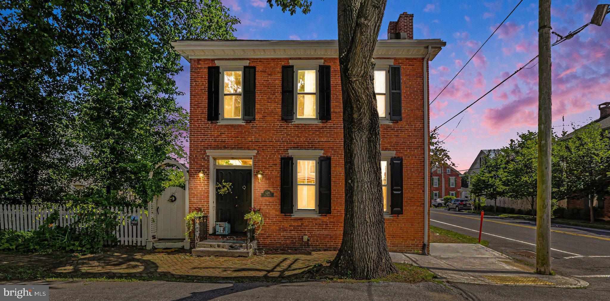 Historic Village Living in the Heart of Boiling Springs!
Own a piece of Boiling Springs history in this charming 2,500 sq ft Victorian-Federal home, circa 1880, ideally located in one of South-Central Pennsylvania's most beloved villages. This distinctive home offers 3 bedrooms, 2 full bathrooms, two propane gas fireplaces, and an open living and dining area that blends historic character with comfortable everyday living.
A standout feature is the original summer kitchen, now a study/home office—ideal for remote work, reading, or creative pursuits. Throughout the home, refinished yellow pine floors, crown molding, and custom shelving are present. Recent upgrades include rain gutter guards (2022), a new roof (2024), new siding (2025), custom mahogany shutters (2026), and seven Mitsubishi mini-split systems (2022) that provide efficient heating and cooling year-round. Set on a rare double lot, the fenced property features a garden and a historic red barn that once served as Boiling Springs' first fire barn, housing horse-drawn firefighting equipment at the turn of the twentieth century. Today, it provides exceptional storage, workshop, studio, hobby, or automotive space.  Enjoy an unmatched walkable lifestyle. Stroll to Children's Lake for fishing, nature watching, and scenic views, or explore nearby Wittlinger Preserve, Spring Meadows Park, and South Middleton Township's extensive walking and biking trails. The Appalachian Trail runs alongside the lake, and the renowned Yellow Breeches Creek is just minutes away for fly-fishing, kayaking and birdwatching. Daily conveniences are within easy walking distance, including the post office, bank, convenience store, public schools, community pool, and Caffé 101, a local favorite for Mexican-fusion cuisine. A new brewpub is planned for the village's historic mill building. You will have front-row seats at Foundry Day (the first weekend in June) and at all seasonal parades along 3rd Street. This unique property combines historic charm, modern updates, ample outdoor space, easy on-street parking, and a vibrant village setting—an exceptional opportunity to enjoy the best of Boiling Springs living.
