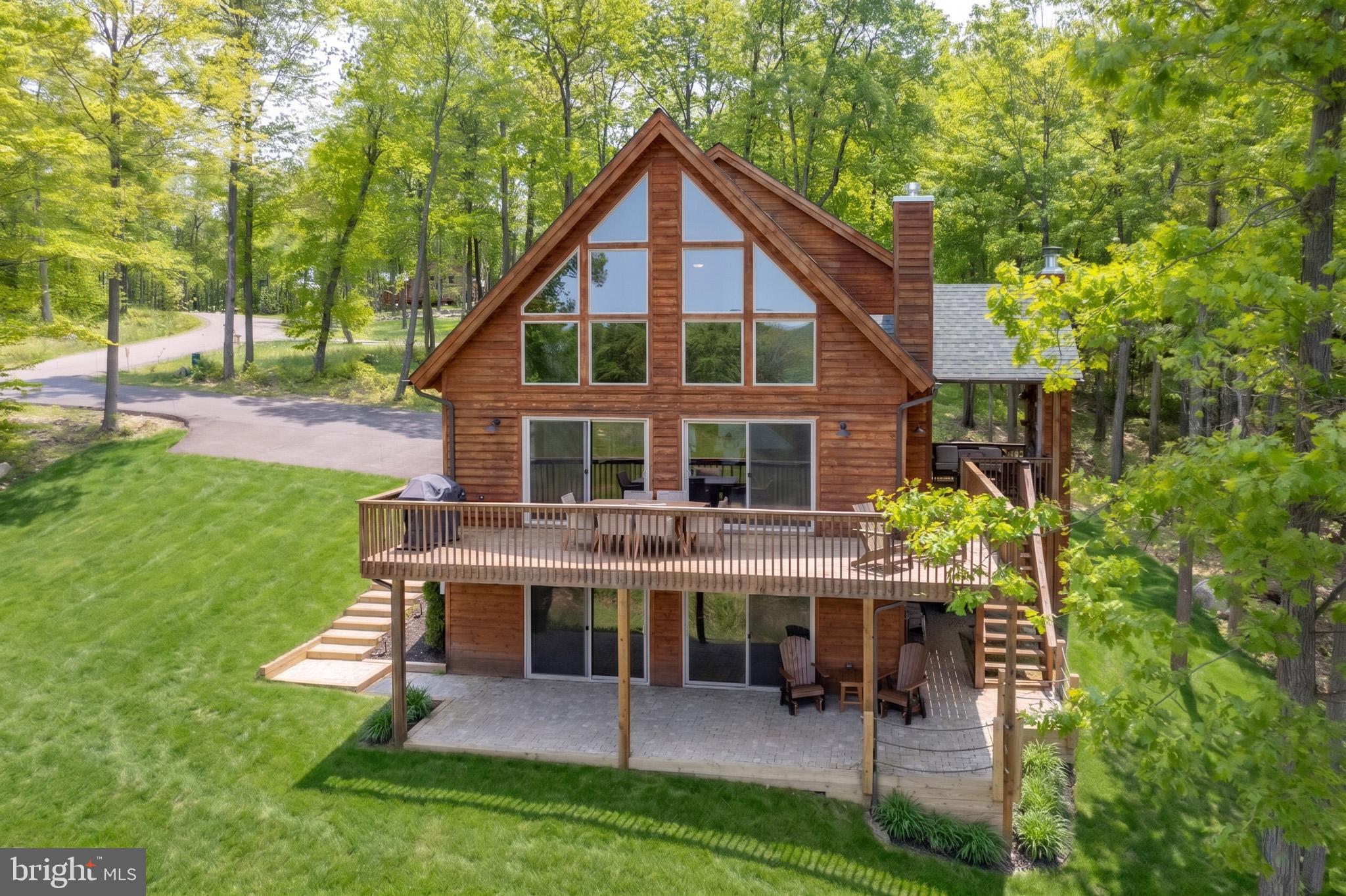 Skiing, Boating and Golfing activities are all only minutes away from this North Camp community 5-bedroom, 4.5 Bath home built in 2023 on 2.623 acres giving you unobstructed views of the mountains all year round.  Also, a Hikers dream as the community borders the Fork Run Recreation Area and the Beige Trail can be accessed from your backyard.  Snow skiers can access the ski slopes only 1 mile away within the North Camp Community.  North Camp is a gated community where homeowners also have access to Deep Creek Lake from Marsh Hill Road which features access to an outdoor pavilion with chairs (first come/first serve basis), and access to fishing from the shore.  This is your vacation, permanent, or rental dream home. One thing that is sure to please is all the space for everyone to spread out and have there own space.  Upstairs loft,  main level living room and large rec room on lover level.  One indoor fireplace and one exterior fireplace just outside of your living room in addition to a Firepit and Hot tub just steps away. Rental numbers on Alpine Spirit for 2024 and 2025 are available.  Alpine Spirit is in the rental Signature Collection.   Paved driveway.  Cedar siding and rain gutter & spouts finish off the outside to give it a perfect Mt. home appearance.
The North Camp community is situated along the north ridge of the Wisp Resort where you have ski slopes & Ropes course & mountain coaster, snow tubing and White water rafting at one of the few man-made white water courses in the United States. Play Lodestone Golf Course (just minutes away) or enjoy any one of 4 other golf courses only a short drive away.   Deep Creek Lake activities such as boat rentals, State Park access, swimming, fishing all close at hand. Convenient access to shopping, dining, healthcare, and year-round outdoor recreation makes this the perfect location for full-time living or a weekend escape.