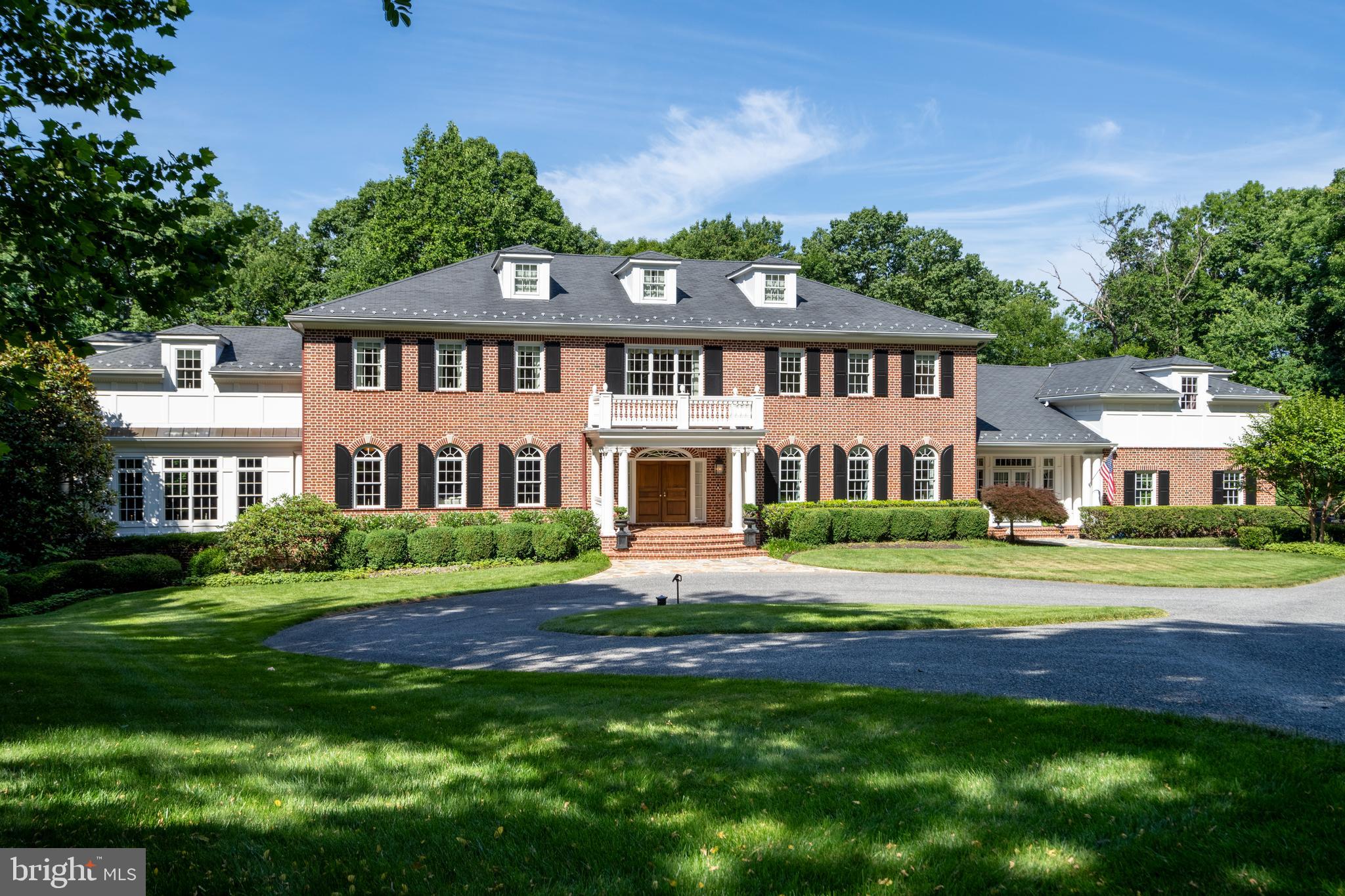 This extraordinary Georgian-inspired estate is a masterclass in refined living—where timeless elegance meets modern luxury to create a private sanctuary designed for both grand entertaining and intimate everyday moments. Encompassing more than 12,000 square feet, every detail of this meticulously crafted residence reflects the vision and care of its original owners.

Nestled on 5.8 acres within the prestigious gated community of Westwicke and backing to protected forest, the setting offers rare seclusion and serenity. A circular drive leads to a stately portico, unveiling a breathtaking three-story foyer crowned by a sweeping, curved staircase that sets the tone for the home’s architectural drama.

Exceptional craftsmanship defines the interiors, from rich Santos Mahogany floors to intricate millwork and striking coffered and barrel ceilings. Formal living spaces exude sophistication, including an elegant dining room with a mantled fireplace and a hand-painted mural by artist Charlie Macsherry—an unforgettable backdrop for gatherings.

At the heart of the home, the gourmet kitchen is both stunning and functional, anchored by an expansive U-shaped island, Blue Pearl granite, and a seamless blend of stainless and paneled appliances. Sunlight pours into the breakfast area, which opens to a balcony with an outdoor grill—perfect for effortless indoor-outdoor living. The adjacent family room, with its coffered ceiling and stone fireplace, flows beautifully into a sunroom and a richly appointed media room with custom built-ins.

Designed for entertaining, the home offers a glamorous billiards room with a decorative tin ceiling and a fully equipped bar—ideal for hosting in style.

Upstairs, five generously sized bedrooms include a luxurious primary suite complete with a gas fireplace, spa-inspired bath with steam shower and soaking tub, and a dedicated dressing room. Secondary bedrooms feature custom built-ins and well-designed shared baths.

A thoughtfully designed north wing enhances everyday living with a mudroom, playroom, and a whimsical indoor slide connecting to the lower level. Above, a private guest suite, full bath, and home office provide flexibility and comfort.

The lower level transforms leisure into an experience, featuring a full stage, projection screen for cinematic evenings, a half-court sport court, and an arcade—creating the ultimate entertainment destination.

Blending classic architecture with exceptional amenities, this one-of-a-kind residence offers a lifestyle of unparalleled comfort, privacy, and distinction.