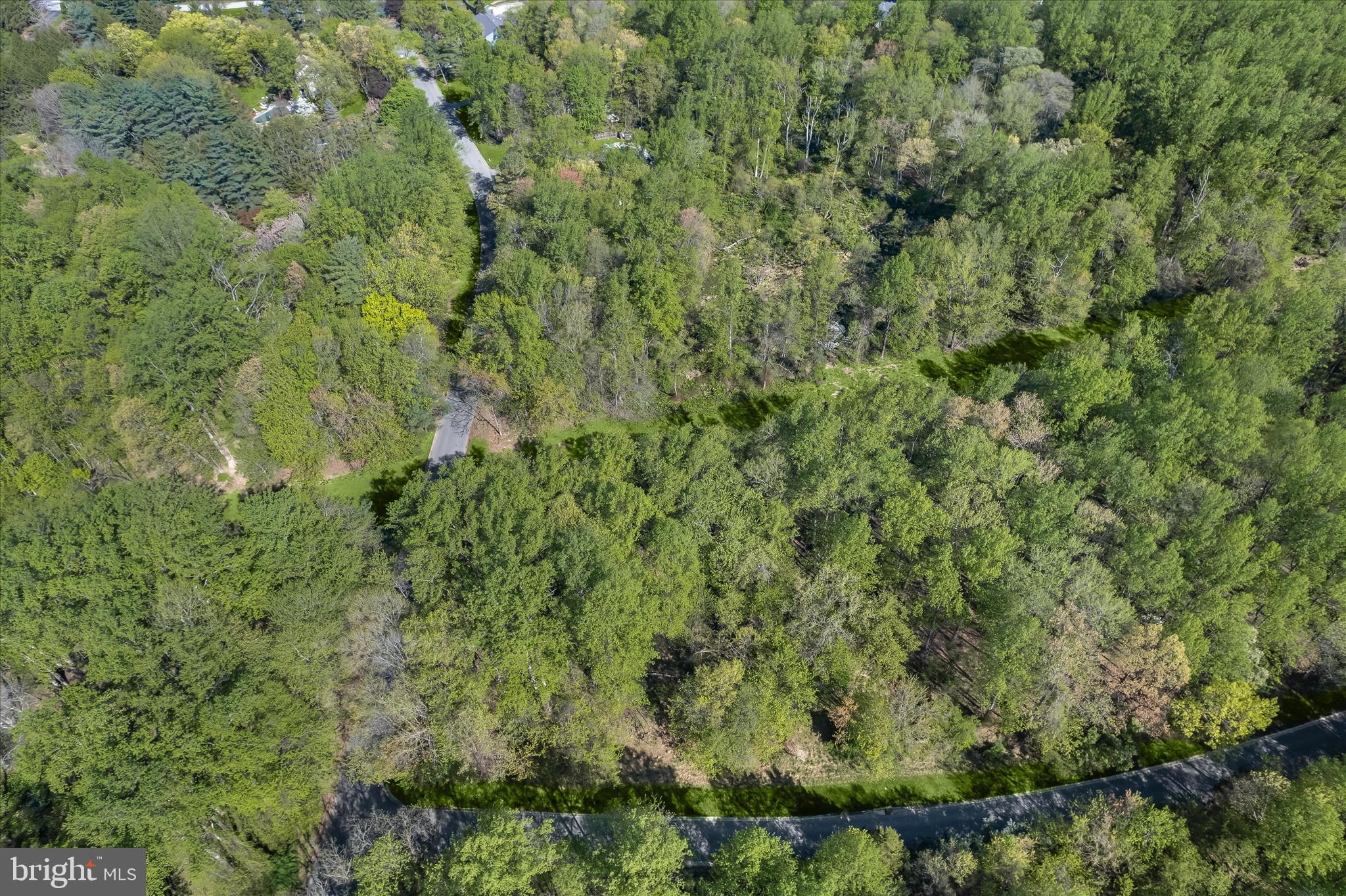 Excellent opportunity to build in the established The Woods community, known for its mature trees and sense of privacy. Ideally located in Owings Mills just off Greenspring Avenue, this 5.52-acre corner lot offers a serene, wooded setting complete with a natural stream. Approximately one acre presents potential for residential construction, while the remaining acreage enhances the property’s peaceful, natural surroundings. An excellent opportunity for buyers to explore development options, with buyers’ full due diligence required to determine land use, utilities, as well as septic and well feasibility. Property is subject to an existing easement in favor of the Transcontinental Gas Pipeline Corporation.