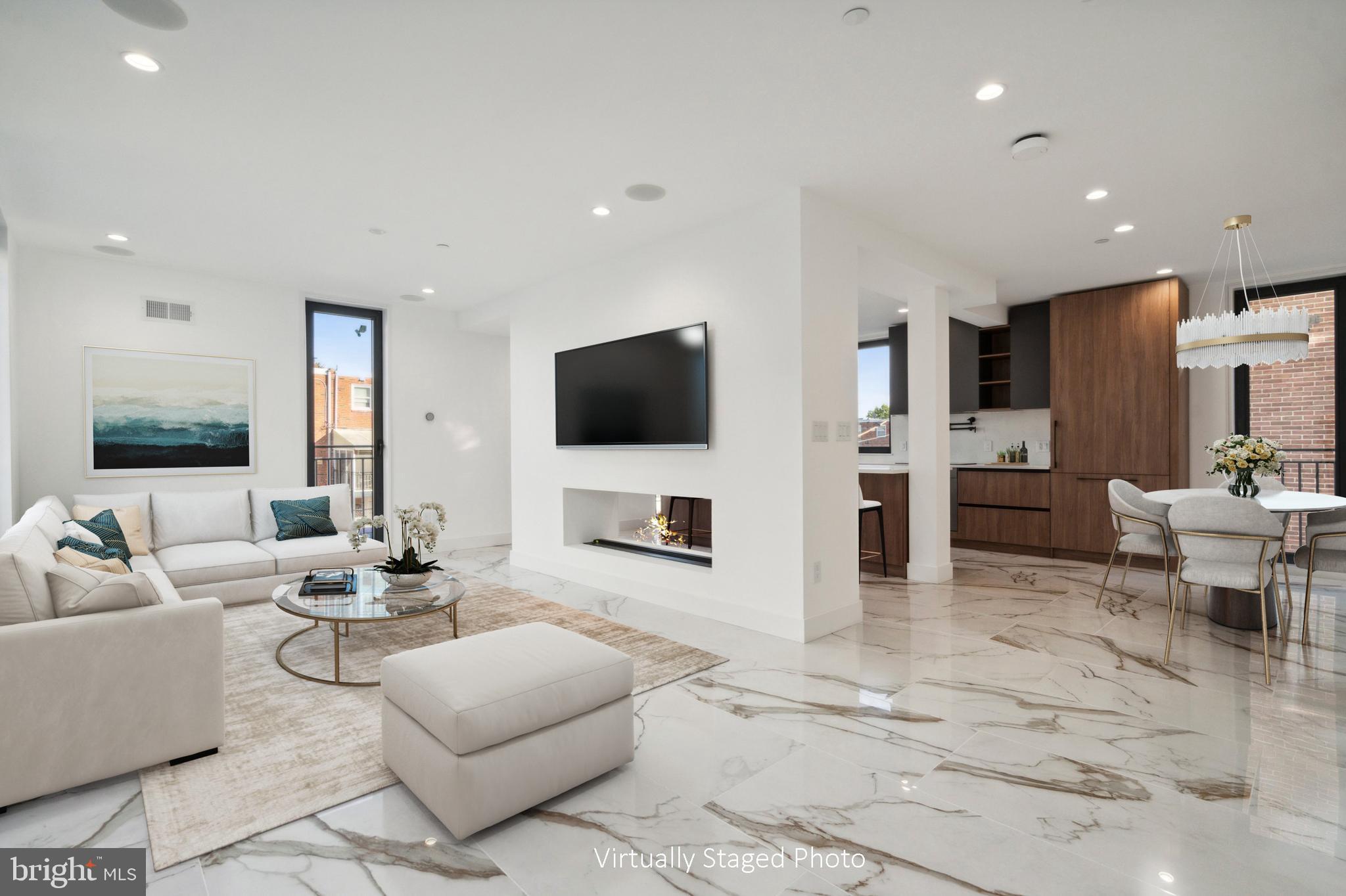 Welcome to La Maison Luxury Residences – a rare and refined opportunity to experience the pinnacle of modern French-inspired living in the heart of Philadelphia. This exclusive boutique townhouse development offers the perfect combination of sophisticated design, cutting-edge technology, and luxurious finishes that will exceed every expectation.

Each meticulously crafted home features a spacious, open-plan layout with an emphasis on light and space. Imported floor-to-ceiling Italian windows flood every room with natural light, offering beautiful views of the vibrant city. The stunning Italian tile throughout the residence sets the stage for opulent living, complemented by radiant flooring in all bathrooms for an extra layer of comfort.

The gourmet kitchen is a chef’s dream, boasting cabinet-faced appliances, a built-in wine fridge, and a large central island, perfect for both culinary enthusiasts and entertaining.  A generous sized pantry ensures that you have all the space you need to store essentials. 

The heart of the home is the living area, anchored by a double-sided fireplace that creates an inviting atmosphere for both the living room and the kitchen. Seamlessly blending modern luxury with convenience, the home is also fully equipped with smart home technology, allowing you to control your dual-zone HVAC, lighting, garage door, and full-house surround sound system with the touch of a button via tablet.

The primary suite is a true sanctuary, featuring a gorgeous spa-inspired bathroom with a soaking tub, a walk-in shower, and luxurious finishes that create a serene and indulgent retreat. Each of the four en-suite bedrooms offers ample space, elegant design, and privacy for every member of the household. 

The crown jewel of this property is the 5-stop elevator that takes you effortlessly to the panoramic rooftop deck, where you can enjoy breathtaking views of Philadelphia’s iconic sports arenas, bridges, and the city skyline. The expansive rooftop is ideal for entertaining or simply relaxing while soaking in the best views in the city.

This home is located in an amazing, highly-desirable location, offering easy access to public transportation, major highways, and the very best of Philadelphia’s cultural and entertainment destinations. La Maison Luxury Residences is set in a private, gated community, providing ultimate peace of mind with gate card access, a 2-car garage, and additional off-street parking.

With a **10-year tax abatement**, the opportunity to finance with special buy-down rates through a select mortgage company, and the highest level of craftsmanship and design, this is more than just a home—it's a statement.

Experience the height of elegance, sophistication, and modern living. Welcome to **La Maison Luxury Residences**—where your dream home becomes a reality.