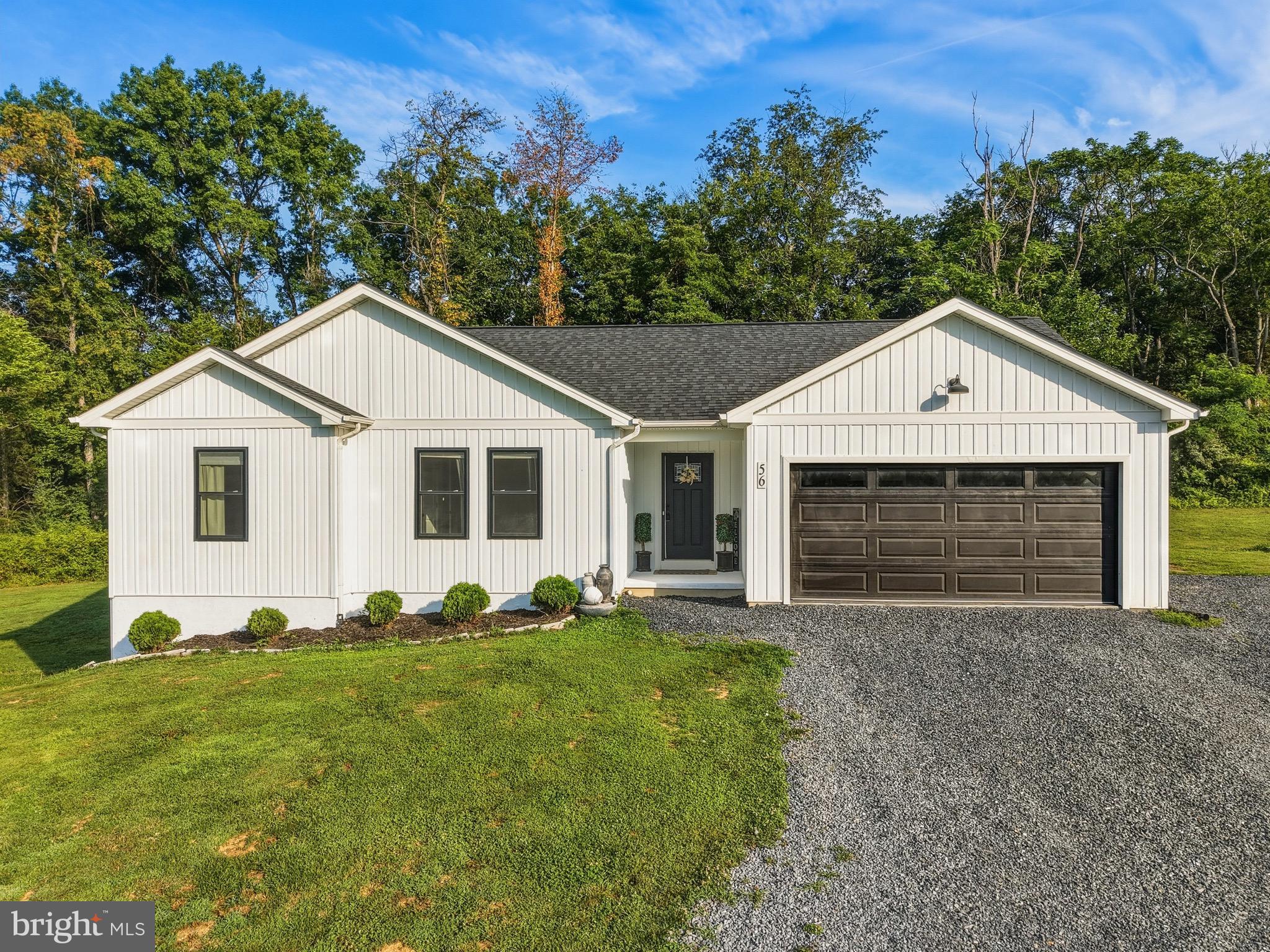 An Address Worth Waiting For… Welcome to Blessed Lane!

Tucked away on a peaceful private road in the heart of the Shenandoah Valley, this beautifully maintained home offers the perfect blend of modern style, comfort, and breathtaking mountain views. Situated on approximately 0.84 acres with a wooded backyard, you’ll enjoy privacy, space to relax or play, and the beauty of nature—all while benefiting from the convenience of a private well.

Step inside to soaring 12-foot vaulted ceilings that create a bright, open atmosphere perfect for everyday living and entertaining. The stunning kitchen features timeless white shaker cabinetry, abundant countertop space, bar-top seating, and a seamless flow into the spacious living and dining areas. The inviting living room is accented by a cozy electric fireplace, beautiful finishes, and large windows that fill the space with natural light.  Just off the dining area, step onto the rear deck overlooking the private wooded backyard—the perfect place to enjoy your morning coffee or unwind in the peaceful surroundings.

The main level offers a spacious primary suite complete with a walk-in closet and private en-suite bath, along with two additional bedrooms and a full guest bathroom.

The lower level expands your living space with a dedicated theater room, home gym, two storage closets, and a large unfinished area ready to be customized to fit your needs—whether it’s a recreation room, workshop, additional living space, or extra storage. An attached two-car garage adds even more convenience.

Outside, gather around the fire pit, enjoy the privacy of the wooded backyard, or simply relax while taking in the beautiful mountain views from the front of the property. Conveniently located just minutes from downtown Woodstock, shopping, dining, wineries, and endless outdoor recreation, this exceptional home offers the perfect balance of privacy, comfort, and convenience.

Welcome home to Blessed Lane—where peaceful country living and modern comfort come together.