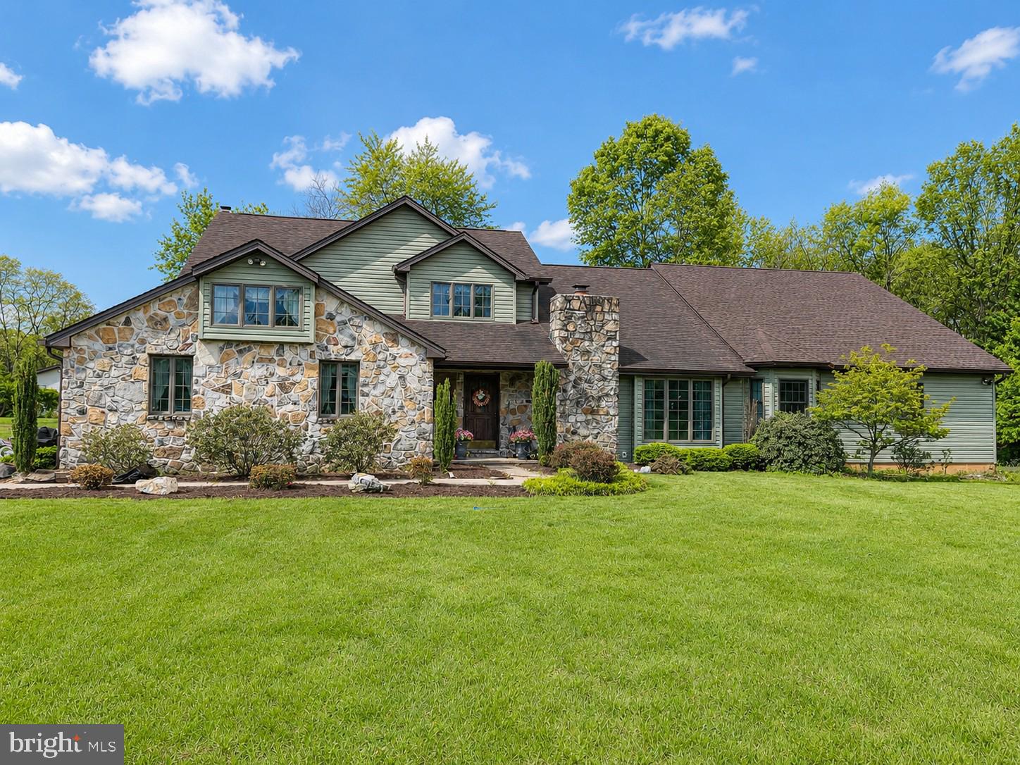 Welcome to this exceptional custom home situated on 2.33 acres of level, cleared land accented by mature trees, offering the perfect blend of privacy and an amazing neighborhood.   Home backs to beautiful farm land and some amazing views.  Featuring 4 spacious bedrooms and 3.5 baths, this beautifully crafted property showcases quality workmanship and thoughtful upgrades   

The exterior combines timeless stone with brand-new vinyl siding for striking curb appeal. Inside, a dramatic two-story foyer opens to an expansive living room highlighted by a stunning stone fireplace and second-story overlook. The updated kitchen features updated appliances, including a new stove &  dishwasher, along with a breakfast bar that flows seamlessly into the bright breakfast nook and inviting family room.

A luxurious main-level addition completed in 2024 includes a second primary suite with an elegant bath featuring premium Brizo fixtures, custom vanities, quartz countertops, and a spa-inspired shower. The suite also offers a cozy sitting area centered around a spectacular 60-inch see-through fireplace.  The Primary Suite includes a Vault Room that every gun enthusiast would love to have.

A spacious mudroom with laundry creates the ideal drop zone for everyday convenience. Upstairs, you’ll find three generously sized bedrooms, including an impressive primary suite with tray ceilings, French doors, and a beautifully appointed en suite bath featuring a dressing vanity, jetted soaking tub, walk-in shower, and oversized walk-in closet with built-ins. All new luxury commercial grade LVP flooring and part of the main house.

Enjoy peaceful outdoor living on the screened-in porch or the expansive deck, overlooking the serene property. In addition to the attached two-car garage, the detached three-car garage provides endless possibilities for a workshop, storage, or hobby space.  New gutters and downspouts are two years old.

Roof is eleven years old and two years old on the addition,   updated HVAC systems, new blown-in attic insulation, and upgraded electrical service with a new 400-amp main breaker and two new 200-amp breakers, offering both efficiency and peace of mind.

This one-of-a-kind property combines space, luxury, and modern updates in a beautiful setting.