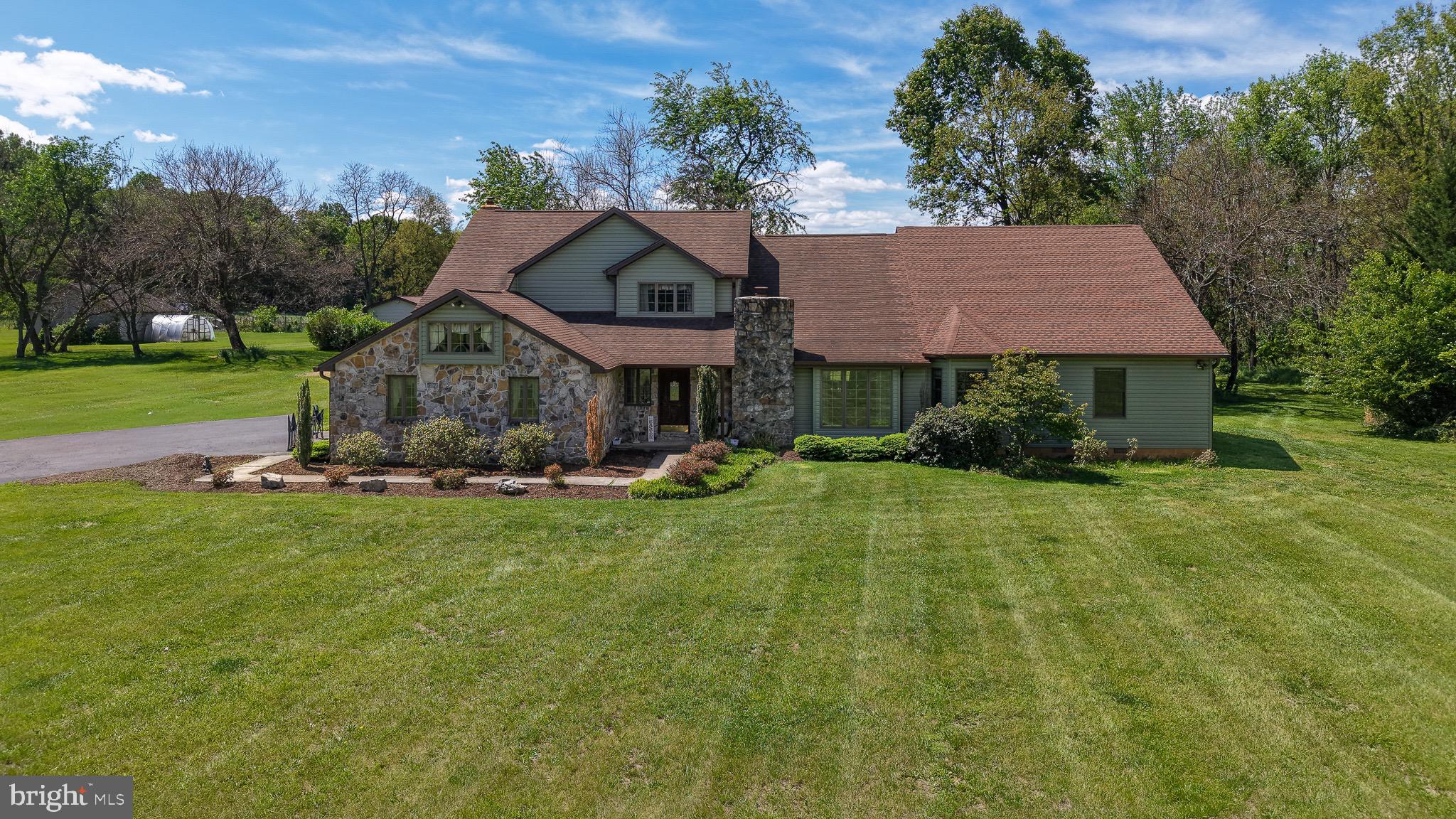 Welcome to this exceptional custom home situated on 2.33 acres of level, cleared land accented by mature trees, offering the perfect blend of privacy and an amazing neighborhood.   Home backs to beautiful farm land and some amazing views.  Featuring 4 spacious bedrooms and 3.5 baths, this beautifully crafted property showcases quality workmanship and thoughtful upgrades throughout.

The exterior combines timeless stone with brand-new vinyl siding for striking curb appeal. Inside, a dramatic two-story foyer opens to an expansive living room highlighted by a stunning stone fireplace and second-story overlook. The updated kitchen features updated appliances, including a new stove &  dishwasher, along with a breakfast bar that flows seamlessly into the bright breakfast nook and inviting family room.

A luxurious main-level addition completed in 2024 includes a second primary suite with an elegant bath featuring premium Brizo fixtures, custom vanities, quartz countertops, and a spa-inspired shower. The suite also offers a cozy sitting area centered around a spectacular 60-inch see-through fireplace.  The Primary Suite includes a Vault Room that every gun enthusiast would love to have.

A spacious mudroom with laundry creates the ideal drop zone for everyday convenience. Upstairs, you’ll find three generously sized bedrooms, including an impressive primary suite with tray ceilings, French doors, and a beautifully appointed en suite bath featuring a dressing vanity, jetted soaking tub, walk-in shower, and oversized walk-in closet with built-ins. All new luxury commercial grade LVP flooring and part of the main house.

Enjoy peaceful outdoor living on the screened-in porch or the expansive deck, overlooking the serene property. In addition to the attached two-car garage, the detached three-car garage provides endless possibilities for a workshop, storage, or hobby space.  New gutters and downspouts two years old.

Roof is eleven years old and two years old on the addition,   updated HVAC systems, new blown-in attic insulation, and upgraded electrical service with a new 400-amp main breaker and two new 200-amp breakers, offering both efficiency and peace of mind.

This one-of-a-kind property combines space, luxury, and modern updates in a beautiful setting. 
Professional pictures are coming on 5/15/26