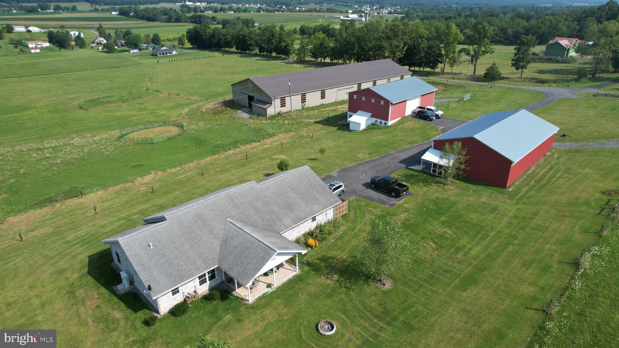 One of a kind Equestrian Facility in the Bellefonte School District with a 1926 sq ft stone Ranch Home, on 31.88 acres.   Acreage is largely pasture (29 acres) with dark forest and ridings paths in the Mountain at rear.   All roads and Farm Buildings are connected by paved surfaces. (Property also listed as Residential, see MLS#PACE2511462).

The home is a spacious Ranch positioned with a view of the surrounding mountains and greenery.  All stone exterior with updated kitchen, granite counters, and stainless appliances.  All rooms have new LTV hardwood flooring and walls and ceilings are hardwood tongue and groove paneling.  With 3-bedrooms, 2-full baths open-style kitchen, dining and living areas that lead to and new a gorgeous rear patio and front porch.  Comfort and security are provided by a new (2022) HVAC system and 2-car attached residential garage.  Size is 1962 square feet.

A prominent feature on the property is a 40 x 50 Bank Barn (circa 1901), with (4) walk-out rear stalls that open to run-out fields, and tack room.  All heavy-duty wood beam underpinning has been replaced and new metal roof completes the Barn exterior.  The heavy-duty Barn floor has trap doors to drop feed and bedding into the stalls.   Full electric service and multi delivery point water to each stall and clean-out points.   The long-term love and care for this Barn (since 1901) provides a very large, dry storehouse for on-site grown Hay and Crop Storage. 

A 72 x 40 Pole Barn Implement Garage has (4) wide bays with 15-foot clear-span for Combine or RV Storage.  High-clearance overhead Doors are insulated with 12 foot clearance. Electric and water are provided to this building as well.   Positioned inside this building is a home and all-facility Generac Emergency Generator.

New construction (2022) is a Regulation Size Dressage Riding Arena (200 x 70) with natural light windows bright arena lights.   Drive in end doors, granular riding surface and a high tech overhead Water Arena manifold Dust Reduction System (all electronic with timers) provides for year-round riding and training.  Large flat space adjoining to the Arena is dedicated space for Horse Trucks, Trailers and RV’s to visit for shows.