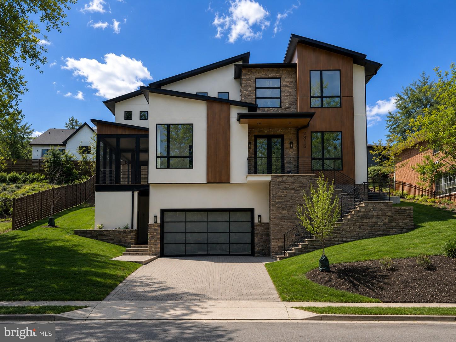 Located on a quiet cul-de-sac in the Country Club Hills neighborhood, this contemporary style, new build from Troutman Homes offers maximum space and comfort.  The highlight of the main floor is the warm and inviting chef's kitchen featuring top-of-the-line Jenn-Air appliances including a 6-burner gas range, separate additional wall oven/microwave combo and separate column refrigerator and freezer.  Natural stone countertops with oversized work island and coordinated bar seating island blend seamlessly into the family room area that includes a gas fireplace.  Behind the kitchen you will find the scullery including glass door cabinetry above additional storage cabinets, countertop workspace with sink and additional refrigerator.  A commercial beverage center under the counter features two refrigerator drawers and separate wine chilling shelves, making this area perfect for coffee or cocktails!  At the rear of the scullery, you find a large, walk-in pantry with plenty of built-in shelves to store all your kitchen staples.  Completing the main floor are the dining room, traditional living room with built-in shelving, an office/den and powder room.

The floating staircase takes you to the upper level of the home.  Here you will find four additional bedrooms, each with en-suite bath.  The deluxe laundry room features plentiful cabinetry for storage as well as convenient open shelves, granite countertops, sink and built-in ironing board.  The owner's suite features a large walk-in closet with built-in shelving and bathroom with an oversized shower including 3 showerheads, built-in bench and separate soaking tub.

The lower level of this home features a large rec room with gas fireplace, two additional bedrooms, 2 full baths and a storage room.

Additional features of this home include a screened porch, grilling area off the scullery, two mudroom-style entry areas with coat hooks and 2-car garage.  Schedule a tour today!