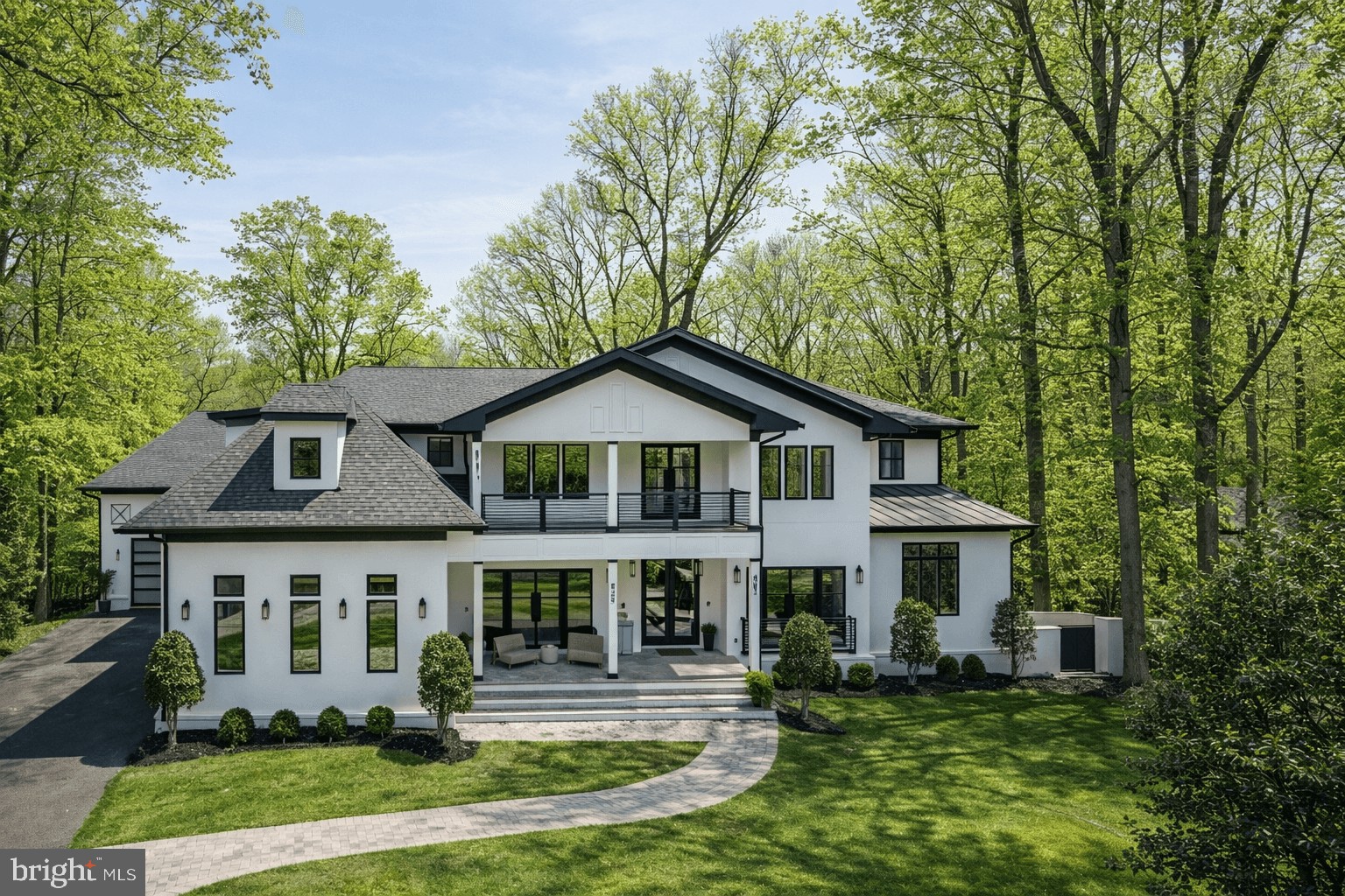 Tucked within the highly sought-after Langley Forest neighborhood, this stunning custom brick and stucco estate is set on 1.47 professionally landscaped acres, creating a private, park-like retreat complete with a picturesque stream and an infinity saltwater pool with elegant fountains.

Spanning over 11,000 square feet, the home blends timeless design with modern luxury, featuring an elevator to all levels and a four-car garage with soaring 15-foot ceilings, ready for car lifts. A gracious foyer opens to formal living and dining rooms, while the inviting family room flows seamlessly to an expansive deck overlooking the serene grounds. The chef’s kitchen is outfitted with top-of-the-line appliances, including a built-in espresso machine, beverage chiller, and separate prep kitchen for effortless entertaining.

Upstairs, the luxurious owner’s suite offers a sitting room with fireplace, private balcony, dual walk-in closets, and a spa-inspired bath with heated floors and a steam shower. Four additional ensuite bedrooms and a spacious laundry room complete the upper level.

Designed for entertaining and relaxation, the walkout lower level features a wet bar, media room, fitness room, guest suite, and flexible bonus space. Outdoor amenities include a covered porch, firepit, golf putting green, and tranquil pool setting surrounded by lush landscaping. Ideally located inside the Beltway with convenient access to top-rated schools, Tysons Corner, major commuter routes, and both Reagan National and Dulles International Airports.