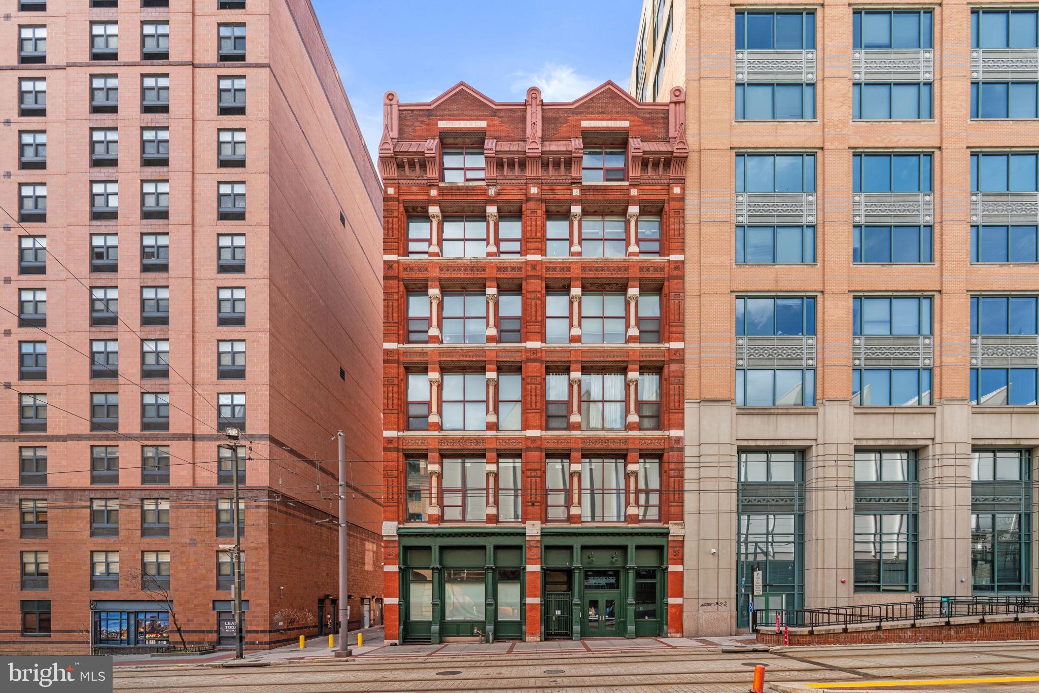 Welcome to 22 S Howard Street #R403, located in the historic Rombro Loft building in the heart of downtown Baltimore. Perfectly situated just steps from the University of Maryland campus, Oriole Park at Camden Yards, CFG Bank Arena, Ridgely’s Delight, and countless restaurants, shops, and entertainment options, this location offers the best of city living.

This beautifully remodeled condo is truly one of a kind within the building. The home features soaring ceilings, large windows that fill the space with natural light, and durable waterproof luxury vinyl plank flooring (installed in Dec 2025) throughout. Stylish barn doors add unique character, while the thoughtfully designed layout offers two spacious bedrooms, each with walk-in closets featuring custom built-ins. The home was freshly painted in 2026, giving the space a clean and modern feel.

The kitchen is equipped with stainless steel appliances and opens nicely to the living area, creating a comfortable space for everyday living or entertaining. Additional highlights include an in-unit washer and dryer.

The building features a brand new elevator with smart access, adding modern convenience and improved accessibility for residents. While the building does not have its own parking garage, several garages surround the building and spaces are available for rent nearby. This distinctive condo offers charm, convenience, and unbeatable downtown access.
