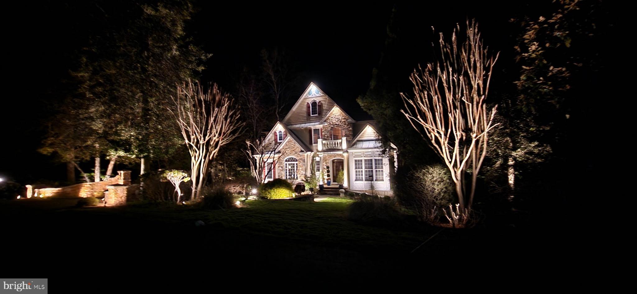 See our Video and 3D Tour Too!  Experience the beauty and craftsmanship of this extraordinary custom-designed Mediterranean-inspired water view home offering over 5,340 finished square feet on three beautifully finished levels. Rich in architectural detail and thoughtfully designed for both elegant entertaining and comfortable everyday living, this 5-bedroom, 4.5-bath residence is truly one of a kind.
A two story grand foyer welcomes you with Italian marble flooring and illuminated tray ceiling  , setting the tone for the exceptional quality found throughout the home. Extensive custom woodwork, arched entrances, and timeless finishes create warmth and character at every turn. The living room features cathedral ceilings and oversized windows that fill the home with natural light, while the stunning great room offers custom built-ins, a stone gas fireplace, coffered ceilings and an entire wall of windows overlooking the private, park-like backyard.
The kitchen is a work of art inspired by Spain, featuring handcrafted Brazilian accent tiles, Saltillo paver flooring from Northern Mexico, and distinctive finishes that make the space both functional and unforgettable.   Love your kitchen counters adorned with Quartzite stone.
Retreat to the spacious primary suite with tray ceiling and a lavish marble ensuite bath complete with dual vanities, oversized soaking tub, and a large walk-in shower.   Relax and rejuvenate in your primary bedroom as it has access to an upper level balcony and hot tub overlooking the parklike back yard.  The upper level also includes three additional bedrooms and two full bathrooms.
The bright walk-out lower level provides exceptional flexibility with a spacious recreation room, fifth bedroom, full bath, and abundant storage areas.
Outside, the grounds feel like a private resort. Enjoy beautifully landscaped perennial gardens, extensive down and uplighting, peaceful water fountains, a koi pond, and two charming swings tucked beneath the deck. Seasonal Magothy River views and views of the pond create a truly tranquil setting.
Located in an exclusive waterfront community offering a pier with boat slips, beach, waterside picnic areas with stone pavers and grills, playground, tennis courts, basketball court, and sports court, this exceptional property combines luxury living with an unmatched lifestyle. All just minutes from downtown Annapolis and within the highly sought-after Broadneck Blue Ribbon school district.