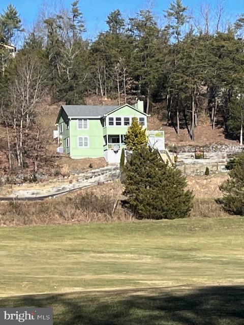LOCATION-LOCATION-LOCATION
Entering Resort Drive from Route 263 -PROPERTY is third on the left.
'GOLFERS'-Driving Range is just across the street.
Just 12 steps to Arcadia.  Open floor plan with an added sunroom for plantings and relaxings.
Three bedrooms and two baths.  Two gas fireplaces.  Shingles replaced in 2014.  New windows installed in 2013.  All appliances have been renewed.  Rec room with bar.  
Patio and planting gardens just out from the kitchen.  Paved driveway with single carport. 
Orientation allows for speedy snow removal from the driveway.