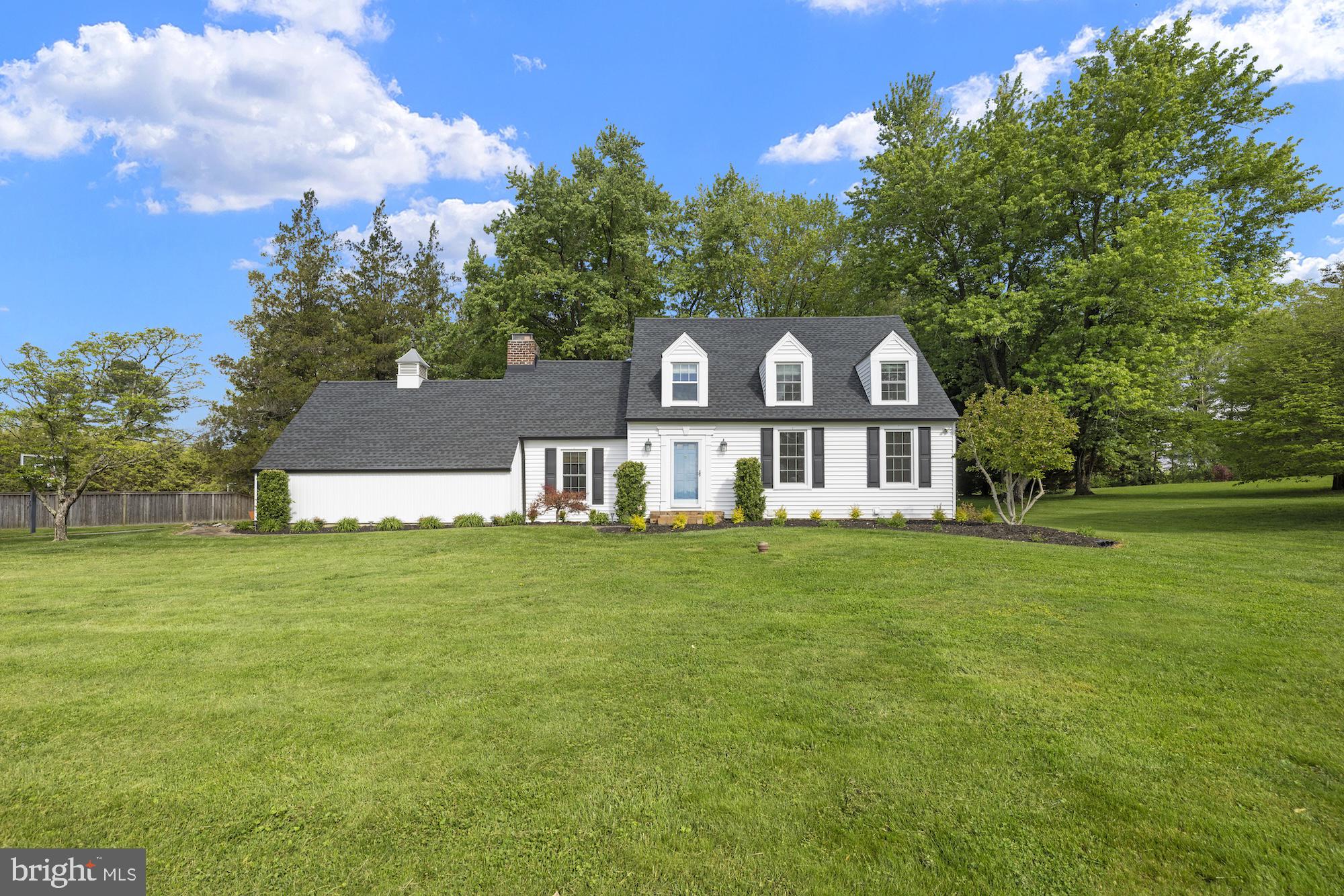Welcome to this charming Cape Cod nestled in a picturesque, private setting, just minutes from shops, restaurants, and major commuter routes. Offering just under 2,900 square feet, this home blends timeless character with thoughtful updates and inviting living spaces throughout. From the moment you arrive, the home’s curb appeal and long private driveway set the tone. Inside, you’ll find a warm and welcoming traditional layout featuring gleaming hardwood floors, abundant natural light, and classic details such as crown molding and wood beam ceilings. Recent updates include a newer roof, gutters (2019), and siding (2021), as well as a well pump and neutralizer (2022), updated electric panel (2022), and a radon mitigation system, providing peace of mind for years to come. The heart of the home is the eat-in country kitchen, complete with a butcher block island, stainless steel appliances, and built-in cabinetry, perfect for displaying your favorite cookbooks or decor. The main level also offers a cozy den with a wood-burning fireplace, a formal dining room, and a spacious living room ideal for everyday living and entertaining.
Upstairs, the three bedrooms offer charm and comfort, featuring walk-in closets and unique touches such as window seats in both the primary suite and hall bath. As a bonus, a sizable unfinished area provides excellent potential for future expansion or customization. The mostly finished lower level adds additional valuable living space with a full bath, abundant storage, and flexible areas ideal for a home office, gym, recreation room, or hobbies. Step outside to enjoy newly landscaped garden beds, a partially wooded rear yard, paver walkways, a rear patio, and a firepit area—perfect for relaxing or entertaining in a private, natural setting. Schedule your private tour today to experience all this home has to offer!