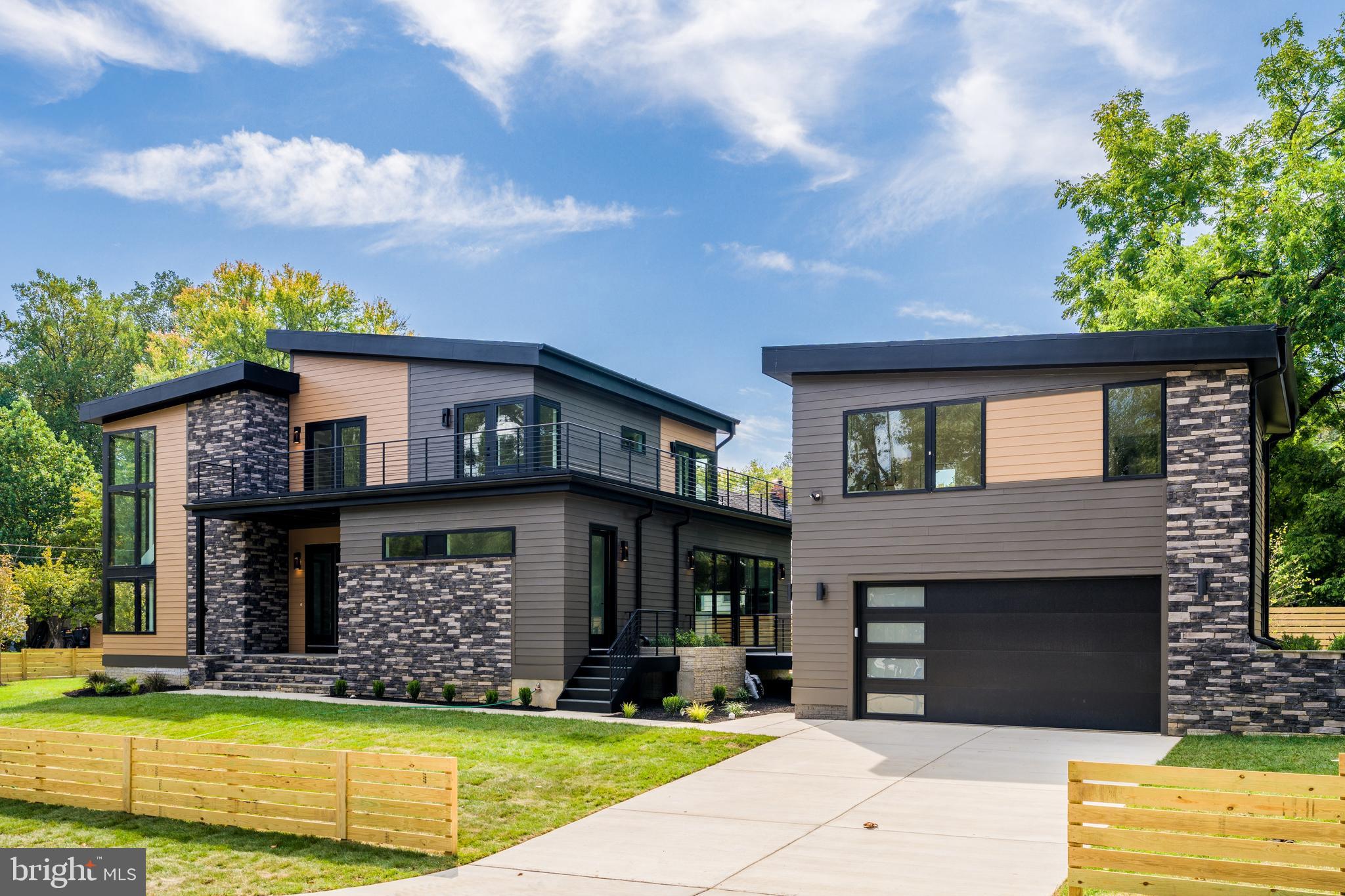 Newly Constructed.  Welcome to this one-of-a-kind dwelling which blends mid-century exterior form with modern interior design.  This stunning 5,600 SqFt custom build with a separate ADU/Apt Loft (400 sf) above the garage (22'x20')  is situated on  1/3-acre premium corner lot.   The residence spans 3 levels with 5 bright bedrooms and 5 luxurious baths (main house).  It has a detached parking garage for 2-cars, plus an additional 4-car driveway.  This home features an unrivaled open-concept plan perfect for modern living and entertaining. The bright living room boasts 10-ft inverted tray ceiling with LEDs, Bluetooth ceiling speakers, fireplace accent wall, and deck access.  The gourmet kitchen features 10-ft waterfall quartz island, JennAir stainless appliances, two-tone cabinetry, walk-in pantry, and sgd to a second Trex deck.  On the main level, there is also an office, bedroom, and full bath.  Next to the dining area is a side door that leads to the mud room with a built-in bench and a pet washing station. A dramatic floating staircase with a corner wall of windows leads up to the vaulted family room with 15-ft ceiling height, skylights, and balcony access door.  The primary suite features floor-to-ceiling windows, luxurious soaking tub and shower, walk-in closet, dry bar, and private access to the balcony. Two other ensuite bedrooms and a separate laundry room complete the upper level. The open basement boasts a large recreation area, gym, wet-bar, ensuite bedroom, and walk-up stairs to the rear yard. The Bel Air neighborhood is tucked away yet minutes from major highways, I-495, I-66, Rt 50, East Falls Church Metro, and key destinations, such as, the Mosaic District, Tyson's Galleria, and Inova Fairfax Hospital. ** It was expertly crafted by NextDayRemodeling and designed by Axis Architects and backed by a Builder's Warranty. **