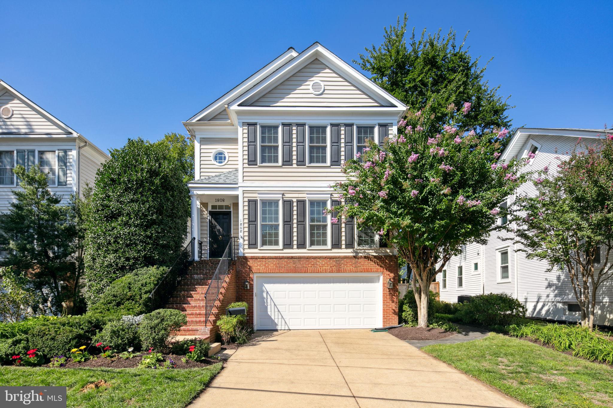This stunning 1999 Colonial in Lyon Village seamlessly blends modern updates with timeless elegance, offering five bedrooms and 3.5 baths across 3,234 square feet of meticulously maintained living space. Set on a 5,249 square foot lot, this home exudes warmth and sophistication. Sun-drenched living and dining rooms boast high ceilings and gleaming hardwood floors, setting a welcoming tone throughout. The inviting family room, anchored by a cozy gas fireplace, flows into a gourmet chef’s kitchen, complete with an oversized quartz island, top-of-the-line appliances, abundant storage, and an impressive range hood, all with views of the private, serene garden.

The second floor features a luxurious primary suite with a spa-inspired bath, three additional generously sized bedrooms, and another beautifully renovated full bath. The lower level offers an au pair suite with a private entrance, including a fifth bedroom, full bath, and a convenient kitchenette, ideal for guests or extended family.

Enjoy outdoor living with beautifully landscaped gardens, whether from the deck or the stone patio, perfect for entertaining or relaxing. Incorporating modern eco-friendly features, the home is equipped with solar panels, contributing to energy efficiency and sustainability. The two-car garage provides ample parking, and the home's prime location is just a short walk to the Metro, shops, dining, and grocery options in Clarendon and Courthouse.

This home truly offers an unmatched combination of style, convenience, and comfort in one of the area's most desirable neighborhoods.