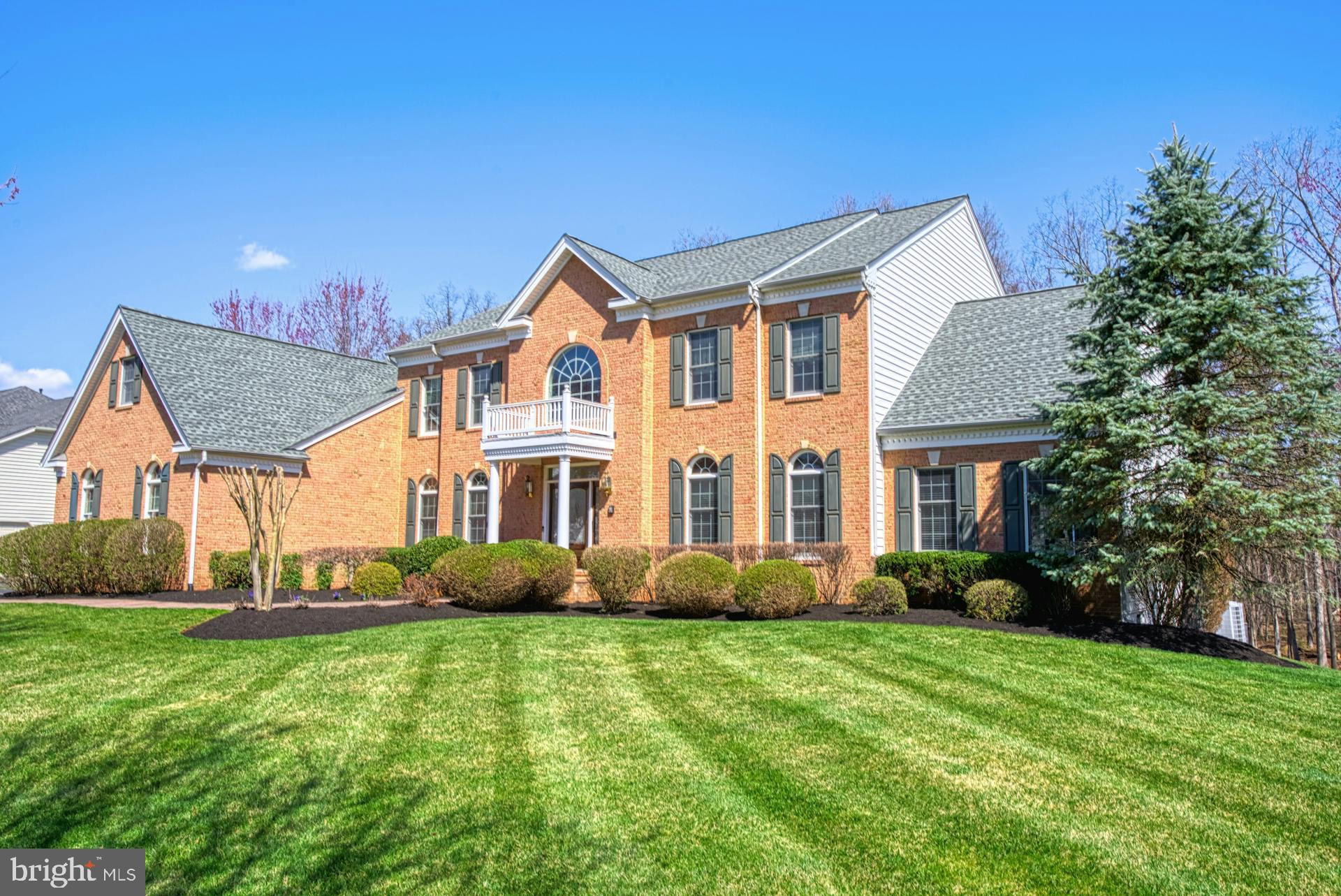 Stately Hampton Estate made for entertaining that backs up to private woods. This home has
8000+ finished square feet on three levels located in the enclave of the much sought-after
Dominion Valley Country Club.  Enter the home's grand foyer with dual staircase that leads into
the soaring two story great room with coffered ceiling and wood burning fireplace.  Showcase your
culinary skills in the main level kitchen with granite countertops, oversized island and cherry
cabinets.  Recently upgraded appliances   include,  combo ThinQ wall oven with convection/microwave, dishwasher, refrigerator,  wine cooler, washer and dryer.
The main level has both a formal living and dining room, along with a study with a built-in cherry bookcase.   The upper level has a large master suite with sitting room, two walk-in closets and spa-like bath; three upper level bedrooms each with private bath.  Two bathrooms have been upgraded within the last month. Hours will be spent in the walk-out finished basement designed for entertaining, complete with custom theater room; the feel of a Tuscan wine closet;  a  "TO-DIE-FOR" custom designed wet bar;  fireplace;  pool table and game areas;  bathroom with walk-in shower; and an extra room with a closet you could use for exercise, playroom, office, etc.
Enjoy outdoor living off the kitchen on a huge TREX deck, plenty of room  for family and friends to enjoy while relaxing to the sounds of nature. Other stand-out features include professional landscaping;  irrigation system; a sitting area off of the walkout basement.   The garage has a professional high-quality floor coating to give it a stylistic edge that matches the elegance of the home.  The garage includes an unused circuit to the left of the irrigation control panel which is pre-wired to the circuit breaker panel area to deliver the current for an EV charger.  
Every day is a holiday in Dominion Valley with community amenities like the Arnold Palmer Golf
course, Fitness Center, Aquatics, Tennis,  Paddleball courts and indoor basketball courts. 
Enjoy the on-site dining at the  beautiful PALMER'S Restaurant.