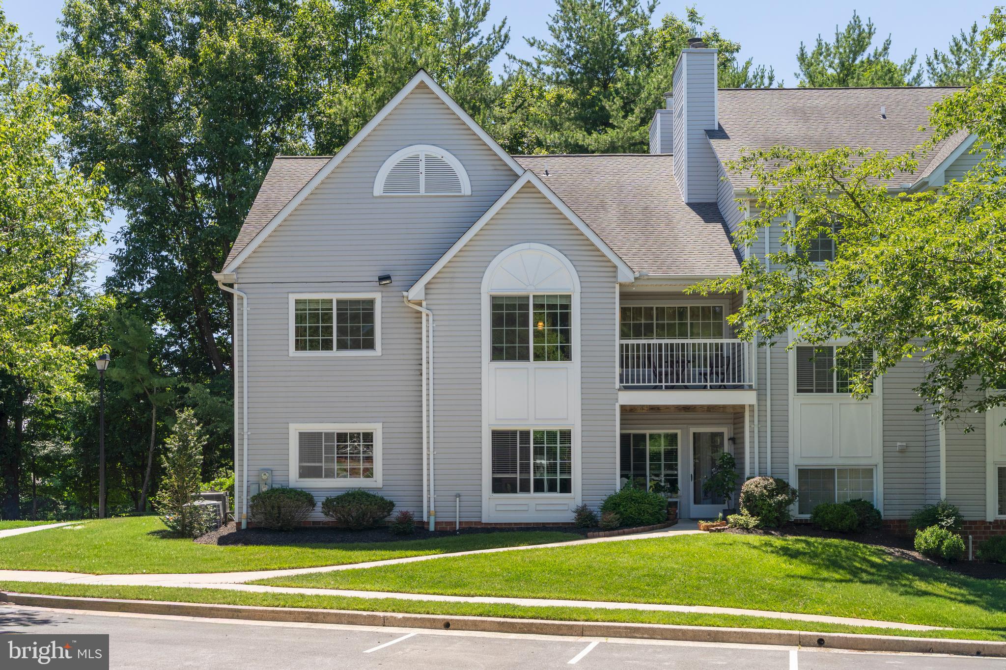 Welcome to 5 Kilcolman Court, a rarely available top-floor condo in the highly sought-after Mays Chapel community of Lutherville-Timonium. This light-filled, move-in ready 1-bedroom, 1-bath home offers a perfect blend of comfort, convenience, and low-maintenance living.  The open and airy floor plan features vaulted ceilings, abundant natural light, and a spacious living area anchored by a cozy wood-burning fireplace and built-in bookcases. The open kitchen includes generous cabinetry, a functional layout, and stylish pendant lighting over the peninsula, seamlessly connecting to the dining and living spaces, ideal for everyday living and entertaining. The generously sized bedroom offers a walk-in closet and en-suite bath, providing both comfort and functionality. Additional highlights include in-unit laundry, excellent closet space throughout, and a private balcony overlooking mature trees.  A private side entry with stairs leads to this top-floor unit, enhancing the sense of privacy and a townhouse-like feel. Enjoy a peaceful setting while being just minutes from I-83, I-695, shopping, dining, Graul’s Market, walking trails, and golf courses. Starbucks and local dining and conveniences are just a 9-minute walk away! A rare opportunity in Kilcolman Gardens, don’t miss this turn-key home in one of Mays Chapel’s most convenient and desirable locations.