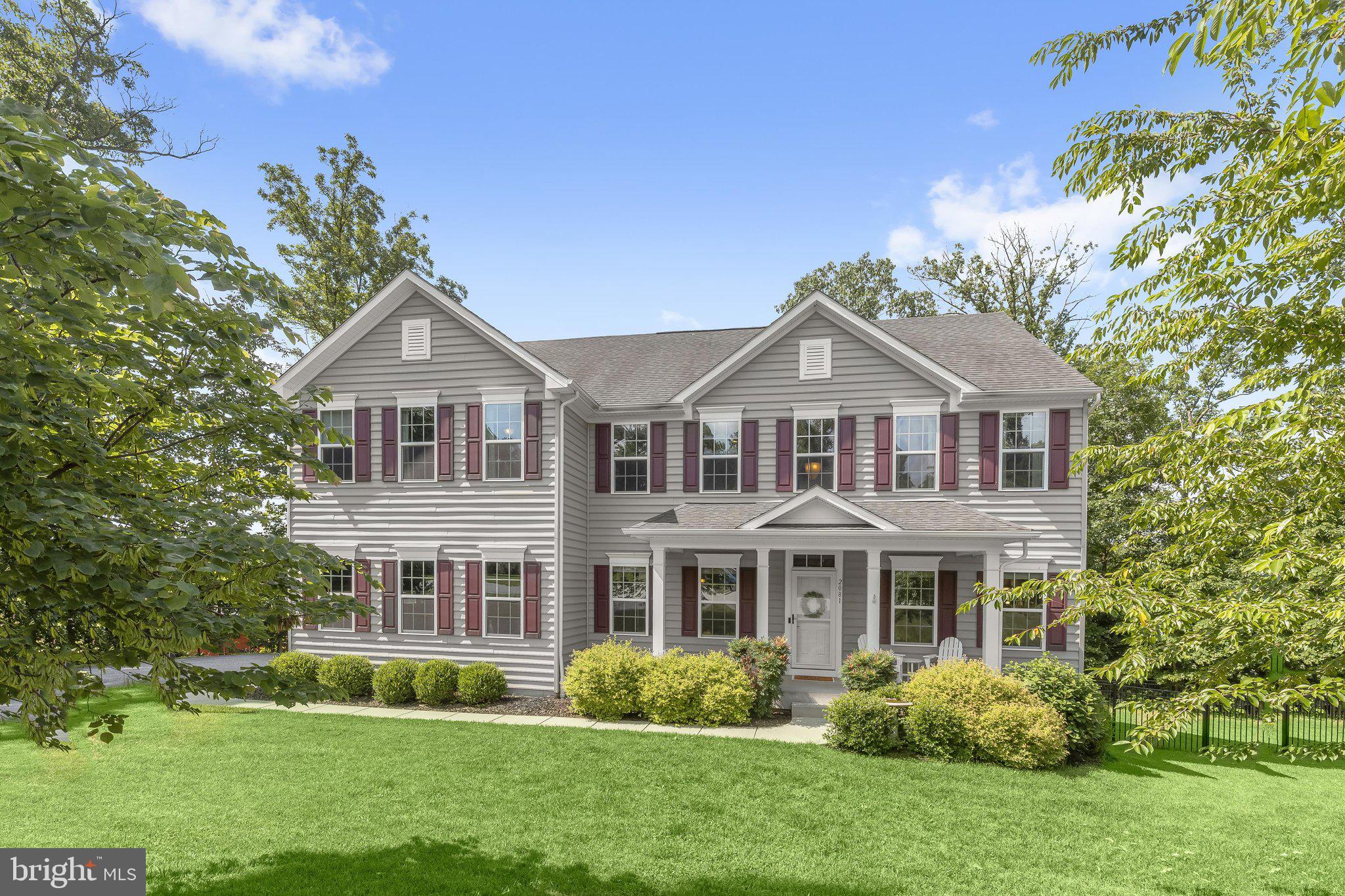 Welcome to 2081 Mountain Ash Court, a luxury single-family home in the highly sought-after Oakmont Overlook community of Hampstead, Carroll County. Showcasing exceptional curb appeal with a welcoming covered front porch, this impressive residence features 9-foot ceilings, classic moldings, rich hardwood floors, and light-filled interiors designed for comfortable everyday living and elegant entertaining.
A gracious two-story foyer is flanked by formal living and dining rooms, creating a warm and inviting first impression. At the heart of the home, the gourmet eat-in kitchen is beautifully appointed with an expansive center island with breakfast bar and pendant lighting, granite countertops, decorative tile backsplash, sleek stainless steel appliances, a walk-in pantry, and a spacious breakfast room with direct access to the composite deck. Just off the kitchen, the inviting family room is anchored by a stunning stacked stone fireplace, while a convenient powder room, mudroom, and access to the finished garage complete the main level.
Upstairs, retreat to the luxurious primary suite featuring an elegant tray ceiling, two walk-in closets, and a spa-inspired en-suite bath with dual vanities and a glass-enclosed shower. Three additional generously sized bedrooms, a full bath, a convenient laundry room, and a versatile loft with new luxury vinyl plank flooring provide plenty of space for family, guests, or a home office.
The finished lower level expands your living space with a spacious recreation room, a full bath, and walk-out access to the backyard, making it ideal for entertaining or relaxing.
Outdoor living is equally impressive with a 22' x 14' composite deck featuring a dual staircase, a custom 14-foot circular stone patio with a firepit, and a beautifully landscaped backyard perfect for gathering with family and friends. Additional highlights include a finished garage, custom under-deck storage shed, and gutter guards, completing this exceptional property that seamlessly blends luxury, comfort, and thoughtful upgrades.