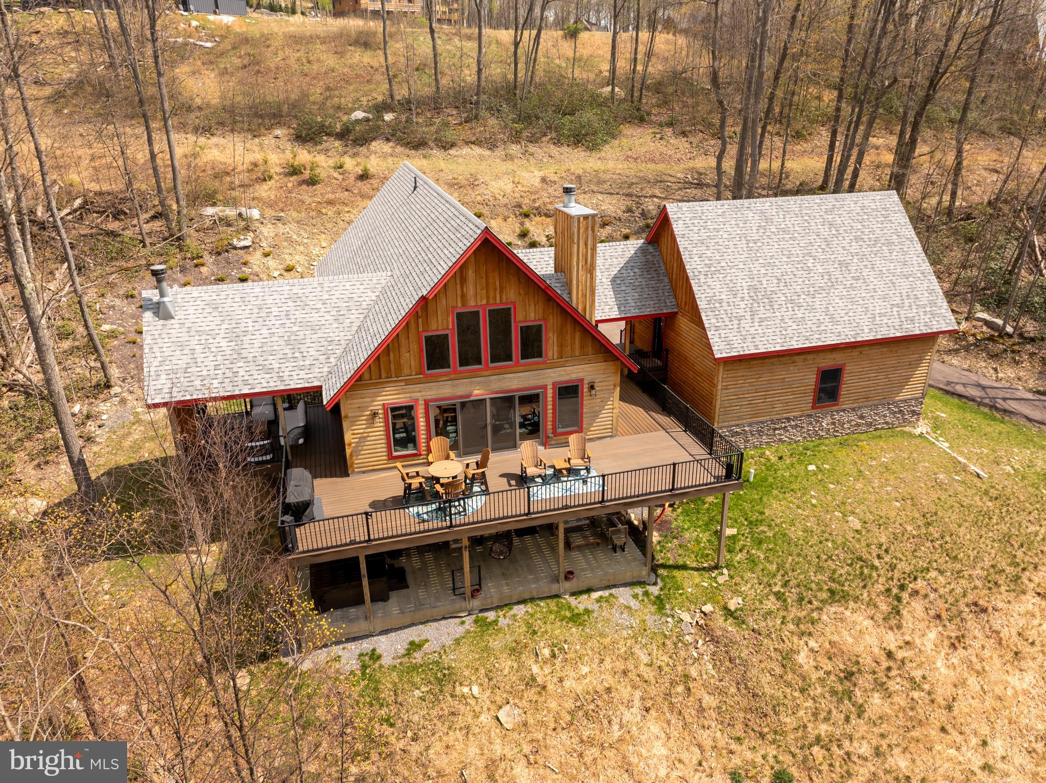 The most private home in North Camp! Special is an understatement when it comes to this 5BR, 4.5BA custom-built mountain masterpiece WITH garage! Perfectly placed on oversized 3.34 acre lot, BEYOND the end of an already private cul-de-sac, you'll find Parhelion Chalet in all of its splendor. All by its lonesome and overlooking a gorgeous mountain view,  every feature of this home was designed to blend into the treetops and amplify the amazing outdoor experience. Mountaineer Log Home design and built by Joe Dixon, one of the most sought-after builders on the mountain. Features include multiple master suites, gourmet kitchen with Amish made cabinetry, rec room with pool table & games, built-in bar w/ automatic
icemaker and mini fridge, spacious wrap-around trex deck, fire pit, covered porch outdoor living area with fireplace, hot tub, Tesla universal charger, state of the art electronics and pre-wired for sauna. Home is currently a successful vacation rental with a growing fanbase - repeat rentals and rising income. High quality contents and custom imported furnishings, 3 total fireplaces (2 wood), ample storage in garage and multiple owner closets.