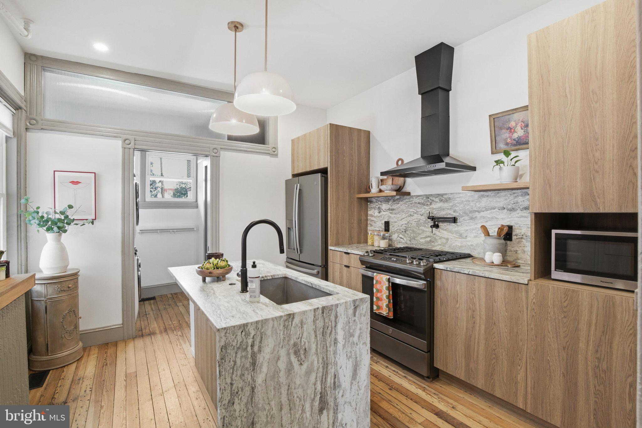 Welcome to a home where Lancaster City's historic character and elevated modern design come together in perfect harmony. Every inch of this thoughtfully renovated residence has been carefully curated to create a home that feels timeless, sophisticated, and effortlessly livable. But wait. This is more than a beautiful home - it's an opportunity to embrace an elevated lifestyle in one of Lancaster City's most sought-after and walkable neighborhoods.
From the moment you step inside, rich solid hardwood floors and oversized windows fill the home with warmth and natural light, creating inviting spaces equally suited for quiet mornings or lively gatherings. At the center of it all is a stunning custom kitchen designed to impress, featuring sleek contemporary cabinetry and a striking natural stone waterfall island that serves as both a statement piece and the heart of the home.

Just beyond, the spacious dining area offers room to host everything from intimate dinners to holiday celebrations, while a conveniently tucked-away first-floor laundry room and stylish powder room add everyday functionality without sacrificing the elegant aesthetic.

The home's beautiful original staircase leads to a versatile second-floor bedroom that also makes the perfect home office, complete with a private balcony overlooking the fully fenced backyard - a peaceful retreat rarely found in the city. The luxurious primary suite feels like a boutique hotel escape, featuring a spa-inspired bathroom with a floating dual vanity, illuminated mirror, and dramatic floor-to-ceiling tile designed for moments of everyday indulgence. The third floor completes the home with two additional generously sized bedrooms, providing flexibility for guests, growing households, or creative spaces.

Beyond its remarkable interiors, this home offers the peace of mind that comes with significant updates, including a new slate roof, new central air system, and maintenance-free front porch and balcony, blending modern convenience with the timeless craftsmanship that makes Lancaster City architecture so desirable.

Location is just as exceptional as the home itself. Nestled on North Lime Street, you're only a short stroll from Musser Park, where neighborhood events and green space invite you outdoors, while Lancaster Central Market, Penn Square, Gallery Row, the Fulton Theatre, local coffee shops, award-winning restaurants, breweries, and countless boutiques are all within easy walking distance. Whether your weekends begin with fresh pastries from the market, afternoons exploring downtown, or evenings enjoying Lancaster's vibrant dining and arts scene, this address places the very best of the city right outside your front door.