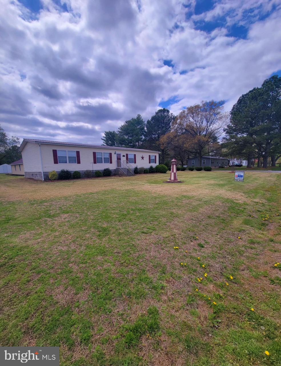 Many breathtaking morning sunrise views and evening sunsets across the field of this lovely home waiting for you. If your seeking a small town community feel,  a country setting, close to larger towns and Salisbury. This is the best decision!  Located in tax free Delaware.  Within  minutes to the Maryland line with a variety of restaurants, shopping, and all the eastern shore has to offer and explore. This home is move in ready with one level living! A very functional large kitchen with center island /breakfast counter, lots of counter space, and storage.  Kitchen leads to the dining area & living room with a cozy gas fireplace to set the mood on those cooler nights.  A laundry room off the kitchen with washer and dryer in place. A split bedroom plan with bonus living area walking to the master suite with a walk-in closet, soaking tub and walk-in shower. Pull into the driveway,  a 2- car garage with a workshop area for all your new hobbies plus overhead storage with drop down stair access. Plenty of parking for a boat/ RV, family gatherings, or entertaining friends sitting on the maintenance free composite decking for the endless summer nights ! Home sits on .73 of an acre and the backyard offers a  dog kennel which can be used for extra storage, and a concrete pad next to the garage!   Newly installed extended composite ramp with solar lighting. A peat septic system installed 2018. Roof replaced in 2021. Come view your next home and fall in love with all it has to offer with room to grow! Sellers are motivated- make your appointment today!