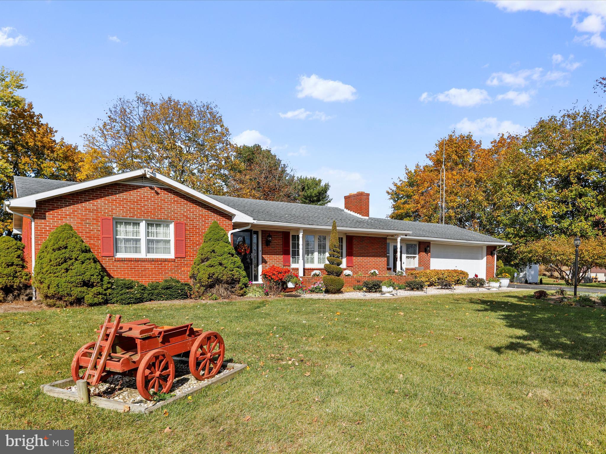 The serenity of rural living yet the convenience  of close reach of interstates and amenities! Welcome home to this lovingly cared for, nicely updated, immaculate brick home. Beautiful inside and out. Upon arrival you'll be greeted by well-designed and maintained landscaping features and a level and spacious lot offering plenty of space for your outdoor living enjoyment with ample front and rear yards. Inside you'll be welcomed into a very large living room with cozy wood stove flanked by a beautiful brick surround and a large bay window providing lots of natural light. The kitchen/dining area boasts Brazilian cherry hardwood floors, granite counters, solid tin backsplash, updated cabinetry,  adjoining dining area and sliding doors to the AMAZING, spacious three-season sunroom (22' x 9'9") overlooking the serene back yard and bordering fields. The primary bedroom is quite large and offers a beautifully updated full bath with impressive tile and granite vanity top.  The main bath is also updated with tile and marble vanity top. The full basement provides a huge family/rec room with another wood stove and an additional finished room perfect for a hobby/craft/work/play room. The unfinished side of the basement provides the laundry area with sink and an impressive amount of storage space. You'll also find a cozy, enclosed breezeway (22'6" x 10') that will surely be a retreat to enjoy, a nice-sized, two-car garage with accessible storage above and other things you won't notice like oak hardwood flooring under most of the main level flooring, security system, outside surveillance system, whole house water filter system, replacement windows with lifetime warranty, and CAC only approx. 3 yrs. old. This home will not disappoint! Finished square footage approx.