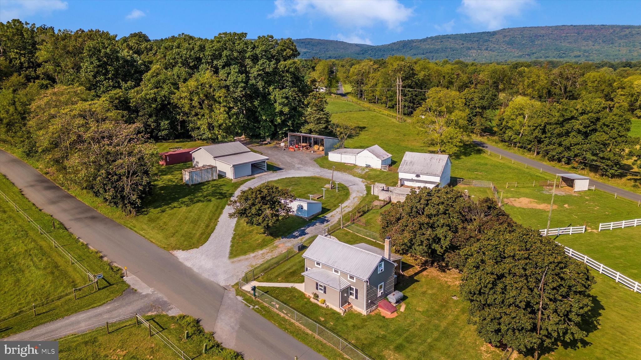 Thinking of a small farm or need a new home for your horses? This 10.95-acre farmette might be just perfect! The property offers a nicely updated two-bedroom, one-bath house, featuring an adorable kitchen with modern amenities, a main-level bedroom, full bath, and convenient laundry area. The home is complemented by a two-car garage and a circular driveway, providing ample parking and easy access.
The farmette is thoughtfully designed for equestrian or small farming needs. It boasts a chain-link fenced yard for pets, 6 fenced pastures for livestock with two water hydrants and a vinyl-fenced riding area. The property is split into two parcels—2.2 acres plus an additional 8.75 acres—offering flexibility and space for various agricultural pursuits. Outbuildings include a tractor shed, a general-purpose shed,  a barn and several run-in sheds with electric, all adding functional value to the property. Whether you are looking to have a small farm or simply desire a rural lifestyle, this property has the potential to meet your needs. Conveniently located close to town, yet with no town taxes, this property provides  a nice balance of rural living and accessibility. Enjoy  country living while being just a short drive from the charming amenities of Thurmont, MD. Don't miss out on this rare opportunity to own a versatile piece of land in a sought-after location!