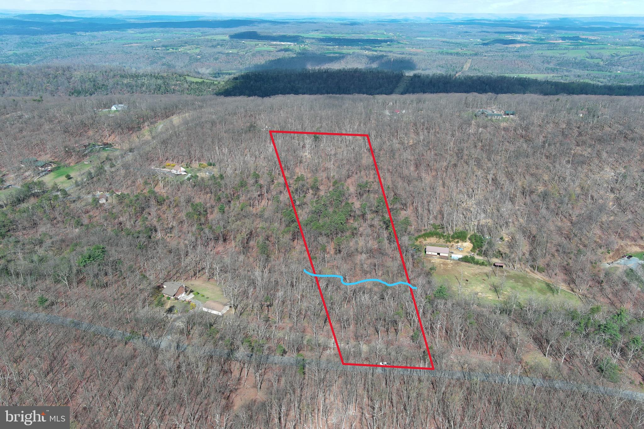 UN - RE- STRIC - TED.......7.2 UNRESTRICTED WOODED ACRES FRONTING ON QUIET PAVED COUNTRY ROAD, LESS THAN 2 MILES OFF RT 50 AND LESS THAN 30 MINUTES FROM WINCHESTER, VA. FLOWING SPRINGS AND WET WEATHER STREAM....MASSIVE HARDWOODS, PINE THICKET, BIG VIEWS FROM THE BACK. MINUSCULE INFRASTRUCTURE COSTS.....SHORT DRIVEWAY TO BUILD SITE AND ELECTRIC WITHIN 30 FT OF BUILD SITE....APPROVED PERK. BIG HOME, TINY HOME, MOBILE HOME.....HUNT, CAMP, SHOOT......NO HOA + NO RESTRICTIONS = NO PROBLEMS! PROPERTIES LIKE THIS ARE AS RARE AS A HEN'S TOOTH AND WILL DISAPPEAR FASTER THAN THAN A POPSICLE IN JULY!