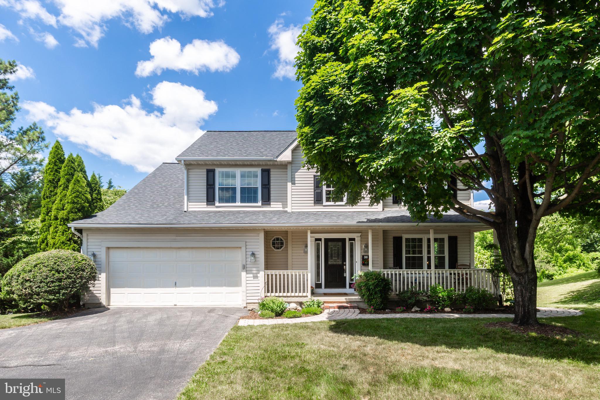 Beautifully sited on a private lot in the heart of Westminster, this 4 bedroom, 3.5 bathroom colonial with 2-car garage offers an ideal blend of modern updates and classic charm. The welcoming 2-story foyer leads to a main level with hardwood flooring throughout, complemented by new Stainmaster waterproof laminate in the family room for both style and durability. The well-appointed kitchen boasts stainless steel appliances, an island, double sink, gas stove, and updated light fixtures. Upstairs, the large primary bedroom impresses with a walk-in closet, cathedral ceiling, and a spacious en-suite bath with a large soaking tub, separate walk-in tiled shower, and dual vanity, while all secondary bedrooms showcase hardwood flooring. The large finished basement provides excellent versatility with a full bathroom, two full-size windows, and a walkout slider to the paver patio with walkway to the front, making it an excellent potential in-law suite. Major systems and exterior components have been thoughtfully updated, including new central AC/furnace in 2024, VYTEX Fortis double-hung windows in 2022, washing machine and dryer in 2025, and a new roof in 2017. Outdoor living is easy with a deck featuring stairs down to the patio and a welcoming covered front porch, while the basement, laundry room, and foyer have been freshly painted to create a move-in ready feel.