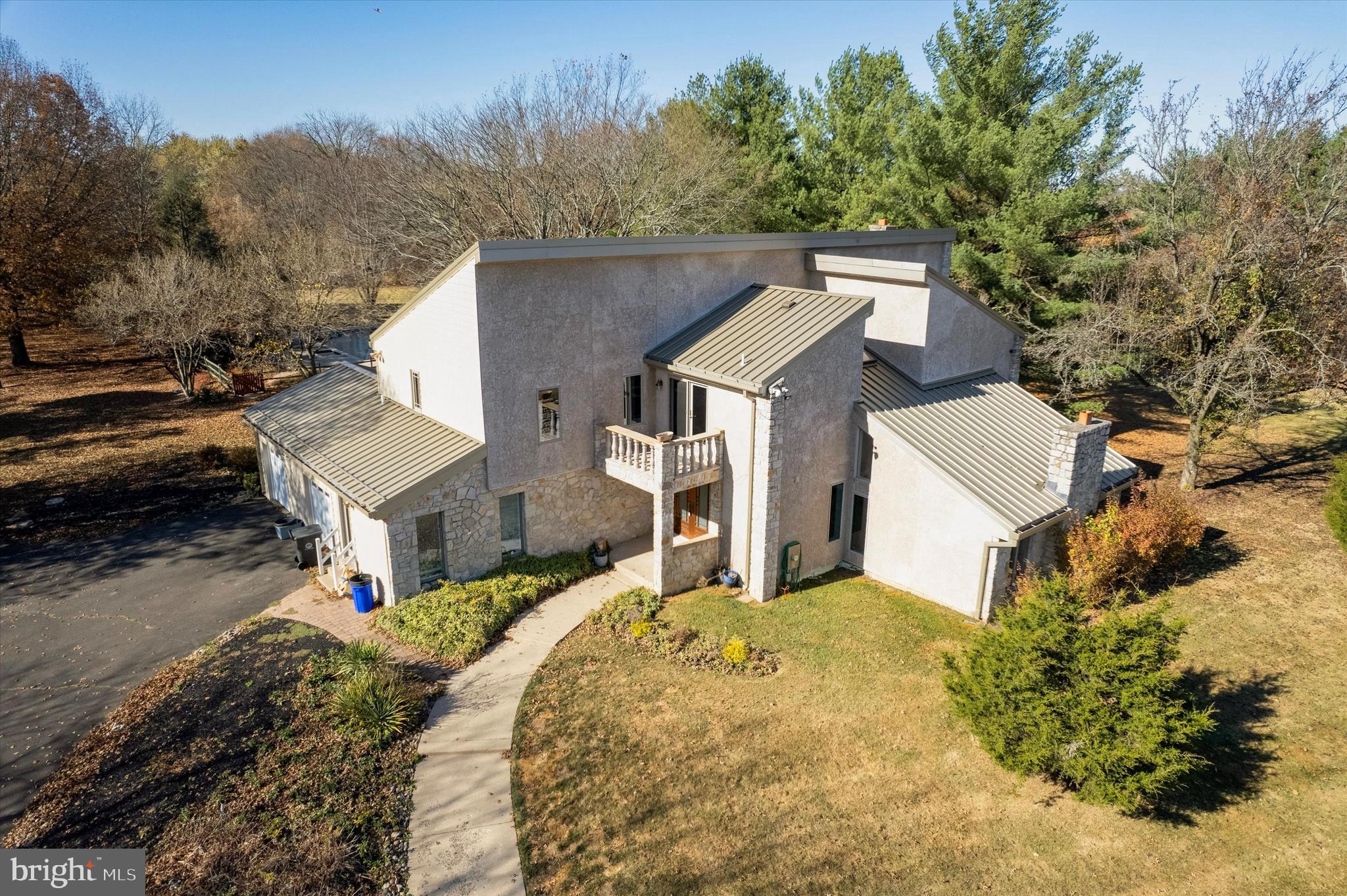 Welcome to 6 Creekside Dr, a one-of-a-kind 10-acre estate in the beautiful area of Bucks County, PA.

This stunning home has been meticulously designed and crafted with the highest quality materials and construction. The magnificent property offers 5 bedrooms and 3.5 bathrooms. Step into the open concept floor plan featuring top of the line engineered white oak hardwood floors and LED recessed lighting that welcome you into a large, bright living room with a beautiful fireplace. The kitchen is elegantly designed and will not disappoint, featuring contemporary cabinetry, quartz countertops complemented by a beautiful backsplash, a double JennAir oven, an extra large island with a modern light fixture above, and stainless steel appliances creating the perfect space for entertaining. The dining room is filled with natural light and ready to host all your holidays and family gatherings. A breakfast nook adds a charming bonus to the kitchen space. Across from the kitchen, the cozy family room with its fireplace makes the entire area warm and inviting. A conveniently located half bathroom is also found on the main floor. Down the hallway, you will find an in-law suite complete with a full bathroom. The laundry room is located nearby, with access to the two-car garage. Step outside from the kitchen to discover an incredible outdoor retreat featuring a custom concrete pool with an electronic retractable cover and a new pool pump creating the perfect haven for relaxation and entertainment. A custom made hand railing and floating steps lead you to the second floor, where you will find three spacious bedrooms with large closets and abundant natural light. The hallway bathroom is elegantly designed with a double sink vanity and a contemporary ceramic bathtub. The expansive primary suite features a vaulted ceiling, a sitting room with access to a private balcony, a large walk-in closet, and a luxurious primary bathroom with a soaking tub, a five-foot shower, a modern double-sink vanity, and a skylight that makes it feel like a spa.

The finished basement offers a complete gym with top-of-the-line equipment such as Tonal, Peloton, a treadmill, and free weights, all enclosed with a custom glass door. There is also a cigar room that can be used as a home office or flex space, along with a large open area perfect for watching sports or kids’ playtime. The two-car garage and extended driveway provide exceptional convenience when hosting large gatherings with family and friends. This remarkable property includes many upgrades, including a new well pump installed to enhance water pressure. The 10 acre property offers endless possibilities whether you envision walking or riding trails, scenic picnic areas, gardening, or establishing an orchard. Don’t miss the opportunity to own this unparalleled home and land that offers the highest level of quality, design, and customization everything you’ve dreamed of in a suburban sanctuary.