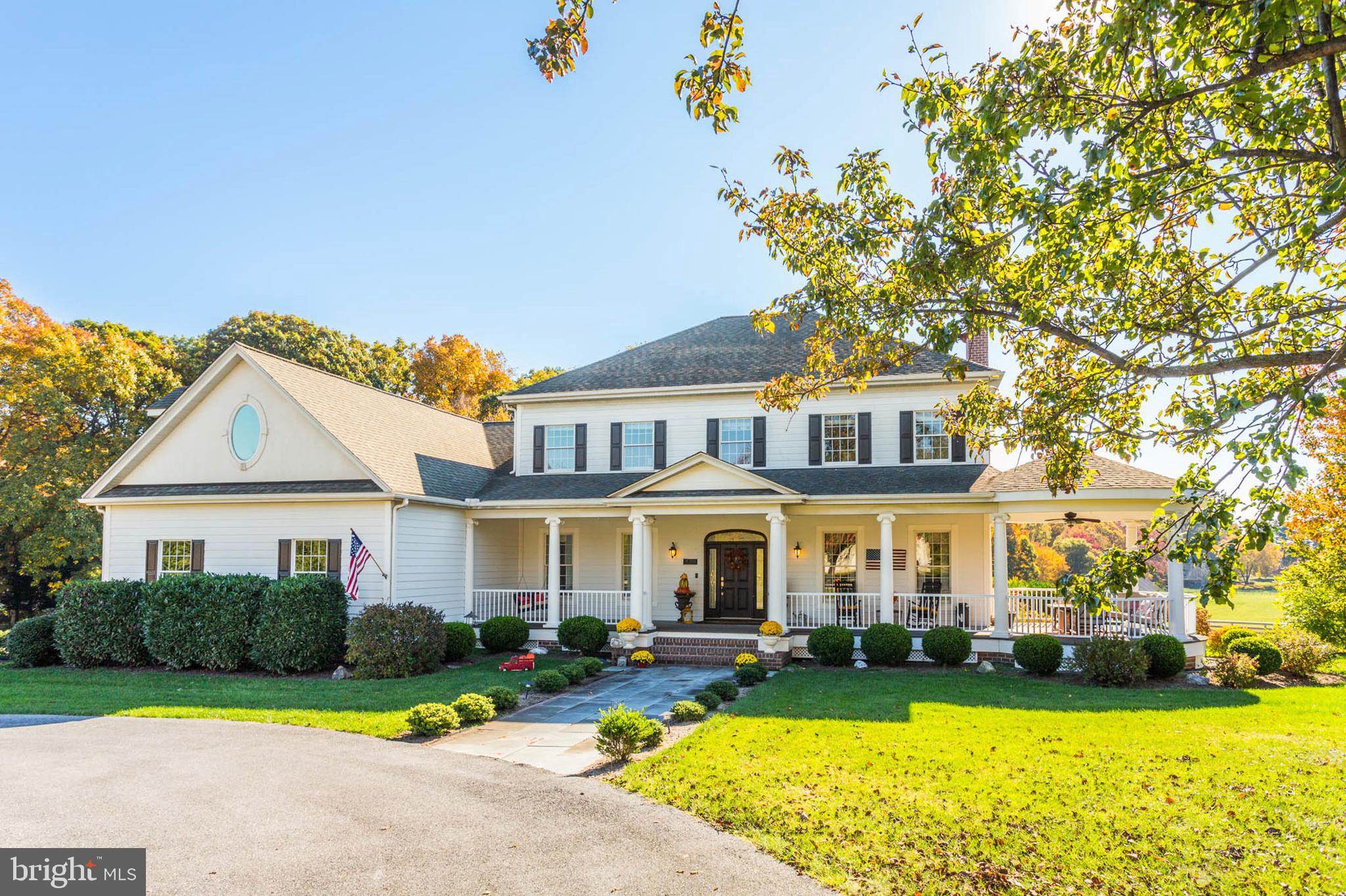 Introducing an exquisite Southern-style colonial residence, complete with a charming wrap-around porch, nestled in the heart of Howard County. Spanning over 6,000 square feet, this magnificent home offers an abundance of space, intricate details, and the modern conveniences you desire in a luxury property—all while exuding a warm and inviting atmosphere throughout its multi-level layout. From the elegant circular driveway to the enchanting front porch and expansive back deck, every aspect of the beautifully landscaped grounds has been thoughtfully curated with care and precision.

The gourmet kitchen, featuring a delightful breakfast nook that overlooks the backyard, is perfect for culinary enthusiasts. The main level boasts a spacious primary bedroom and bathroom, a breathtaking great room, and a grand two-story foyer that welcomes you in style. The formal living and dining rooms are equally impressive, providing elegant spaces for entertaining.

The finished basement is a true gem, offering an in-law suite complete with a full kitchen, bedroom, and bathroom. This space also features a cozy stone gas fireplace, a bar, and a media room ideal for watching games, movies, or hosting unforgettable gatherings. Upstairs, you’ll discover four generously sized bedrooms, each offering stunning views, along with two spacious full bathrooms and an expansive bonus room that can easily serve as a home office, playroom, or comfortable living space for an au pair.

In addition, this stunning custom home is situated within the prestigious equestrian community of Paternal Gift Farm, renowned for its breathtaking beauty and craftsmanship. This award-winning neighborhood showcases twenty-nine luxurious homes, surrounded by forty-nine acres of meticulously maintained pastures. Residents enjoy diverse equine boarding options, a serene private fishing pond, picnic areas, and a scenic 1.7-mile walking path.

Located within the River Hill High School district, this community is conveniently adjacent to Schooley Mill Park, which features a professionally maintained equestrian ring, an eventing course, miles of picturesque riding trails, an exciting playground, and recently renovated sports courts and fields. The unique ambiance and strong sense of community here create an unparalleled living experience. The shared equestrian amenities are expertly managed, ensuring they remain profitable and well-maintained for all residents. The architectural diversity throughout the neighborhood is striking, with each custom luxury home boasting captivating designs and impeccable upkeep.