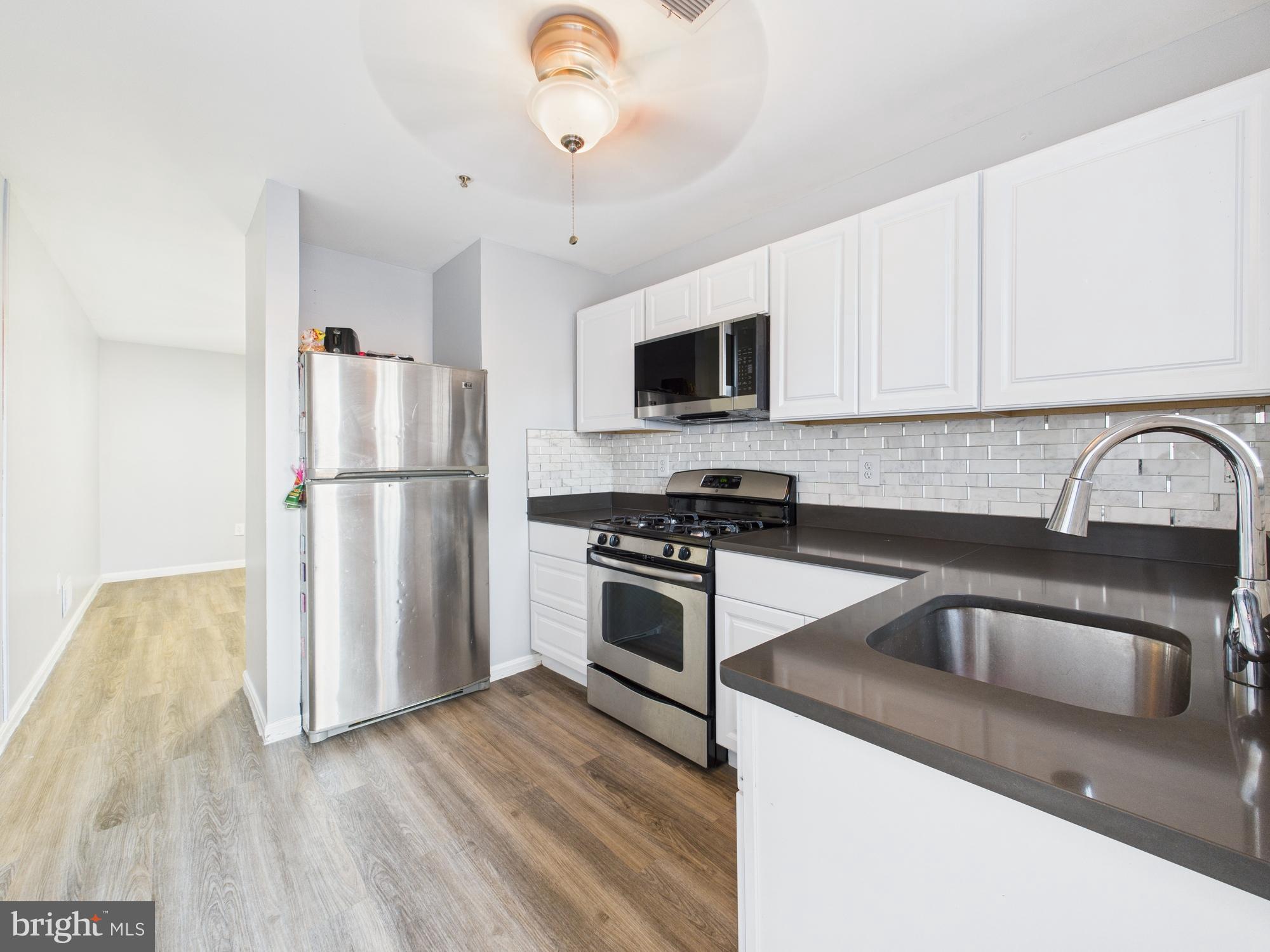 This charming 4-bedroom, 2-bathroom townhouse, renovated and set for new home owner, offers a perfect blend of classic style and modern comfort. The inviting interior features a traditional floor plan with cozy carpeting and luxury vinyl tile, creating a warm atmosphere throughout. The galley kitchen is equipped with a six-burner stove, built-in microwave, and refrigerator, making it a delightful space for culinary adventures. Enjoy meals in the formal dining room or relax in the spacious living areas, complete with ceiling fans for added comfort. Step outside to discover a lovely patio, ideal for morning coffee or evening gatherings. The property is surrounded by sidewalks and street lights, enhancing the neighborhood's charm and safety. With a full unfinished basement, there's ample opportunity for customization to suit your needs. Located just minutes from public transportation options, including a bus stop less than a mile away and a metro station within three miles, commuting is a breeze. Local schools are well-regarded, providing excellent educational opportunities. This home is not just a place to live; it's a gateway to a vibrant community filled with amenities and conveniences that enhance everyday life. Experience the comfort and warmth of this inviting residence, where every detail is designed to make you feel at home.