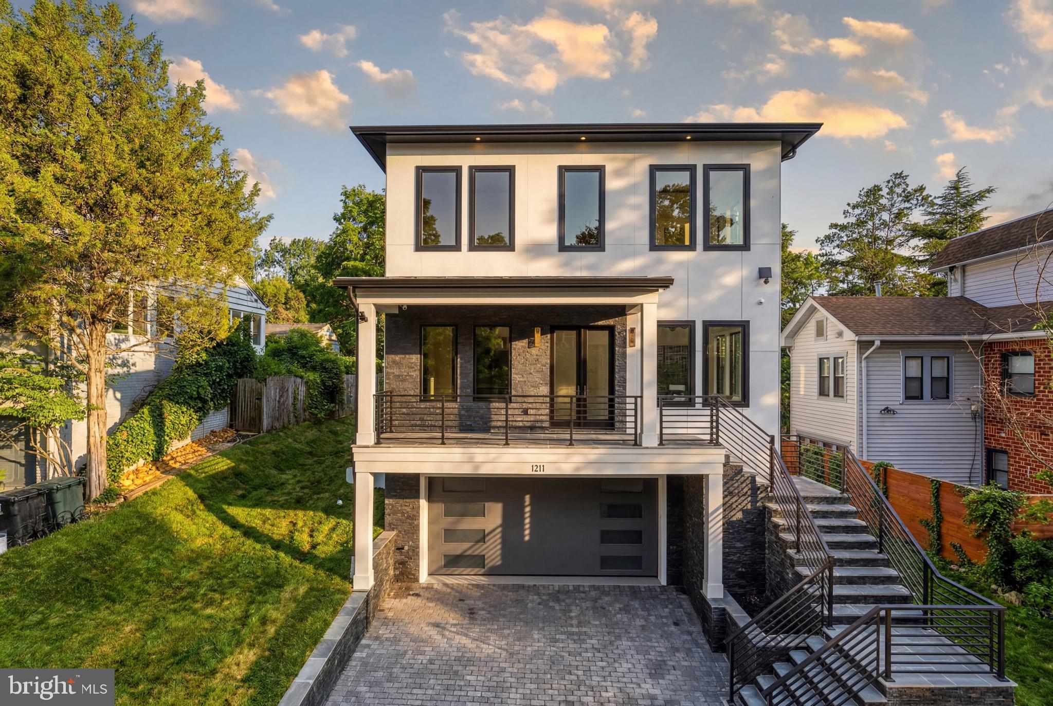 Welcome to this extraordinary newly built custom residence, completed in 2026 and offering  5,545 square feet of exceptional design, craftsmanship, and luxury in one of Arlington's most desirable locations. Thoughtfully designed with both elegance and functionality in mind, this 5-bedroom, 5 full and 1 half bath home delivers a seamless blend of sophisticated finishes and everyday comfort.
A light-filled open floor plan is enhanced by soaring ceilings, oversized windows, wide-plank hardwood flooring, and impeccable attention to detail throughout. Expansive living and entertaining spaces flow effortlessly from room to room, creating an inviting atmosphere for both intimate gatherings and large-scale entertaining.
At the heart of the home is a stunning gourmet kitchen featuring premium Wolf and Sub-Zero appliances, a Miele dishwasher, custom cabinetry, an oversized island, and designer finishes that elevate both form and function.
Every bedroom has been thoughtfully designed as a private suite, complete with its own full bathroom and spacious walk-in closet. The luxurious primary suite offers a peaceful retreat with a private balcony, spa-inspired bath, and an extraordinary custom walk-in closet. A beautifully appointed upper-level laundry room with abundant cabinetry, utility sink, and natural light adds convenience to everyday living.
The finished lower level offers exceptional flexibility with a spacious recreation room, custom wet bar, private bedroom, and full bath, making it ideal for guests, multigenerational living, or entertaining.
Outdoor living is equally impressive with a spacious deck off the main level, a private balcony off the primary suite, and a fully fenced backyard offering both privacy and space to enjoy.
Built with uncompromising quality and timeless design, this exceptional residence presents a rare opportunity to own a truly custom luxury home in Arlington, offering convenient access to Washington, D.C., National Landing, Reagan National Airport, major commuter routes, shopping, dining, and more.