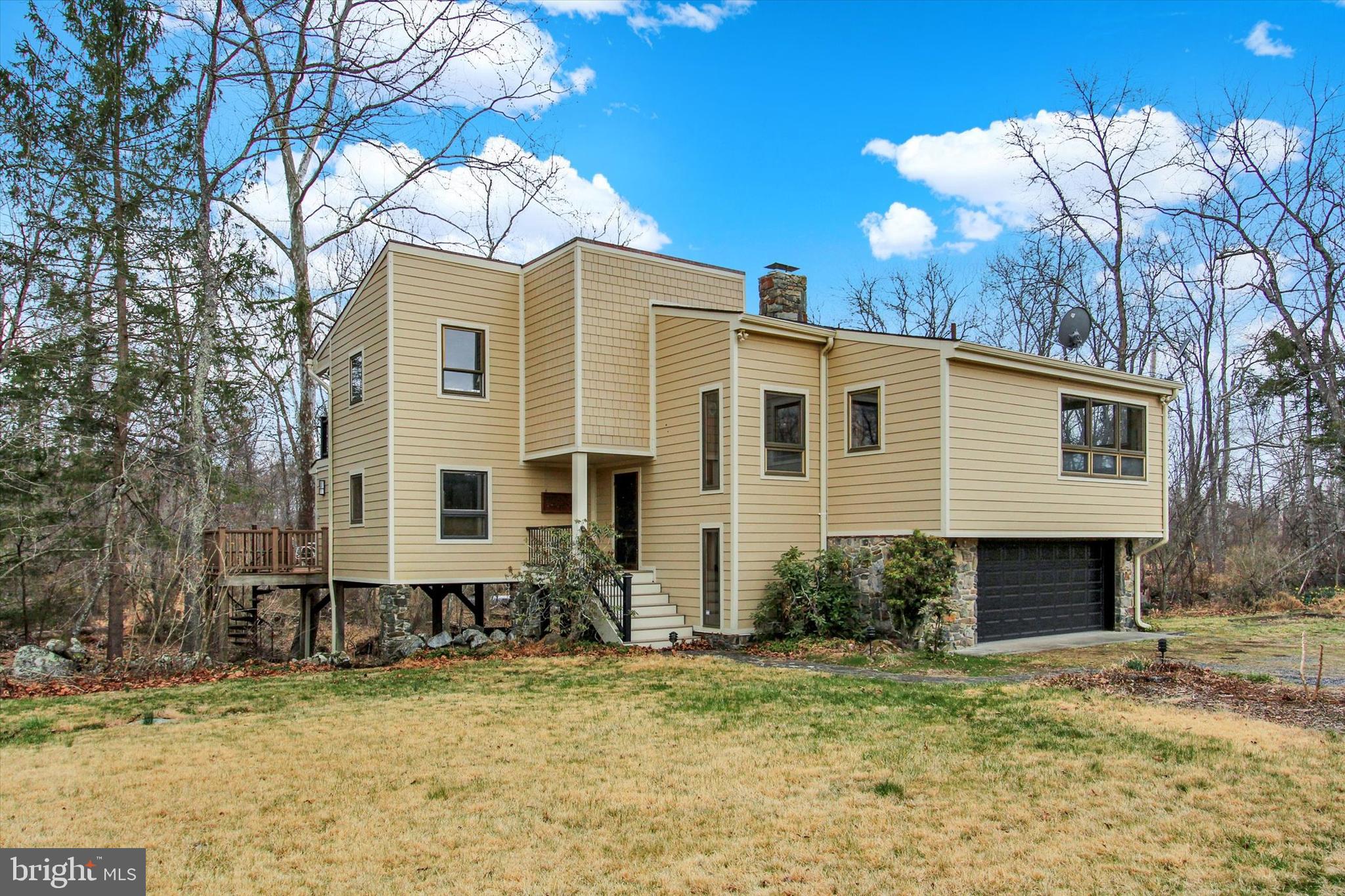 Paradise in the form of rare and stunning 119 secluded, mostly wooded acres with Middle Creek running right through it.  All this just 13 minutes from historic downtown Gettysburg Square.  One huge stocked pond and second smaller pond. Walking paths all through the woods to spy deer galore! Large barn, for horses maybe?  New Hardie board siding, new roof and composite upper and lower decks overlooking Middle Creek just start to cover the amazing house features.  Inside you will find views of the creek from extra large windows in most rooms of the house.  Hardwood floors and real wood features through-out.  The great room features vaulted ceiling with floor to ceiling, wall-to-wall stone-front wood-burning fireplace.  Just off the great room is a sunroom where you are essentially surrounded by the creek. 2 primary bedrooms offer choices for the owner.  One owner's suite with full bath is on the 1st floor and the other owner's suite with full bath is on the 3rd level. Both overlook the creek of course.   Open wood stairs lend an airyness to the house as you  make your way to the 2nd and 3rd levels.  The second level features 2 bedrooms and a full bath.  Open loop geothermal heating system for house and separate gas heater in garage. Diesel generator conveys. Most of the property is zoned rural conservation, but a few acres that run to Bullfrog Rd is zoned Commercial Corridor: Perfect if you are thinking about combining your home with a commercial venture on the same property.  Come take a look and feel your blood pressure lower the second you enter the driveway!