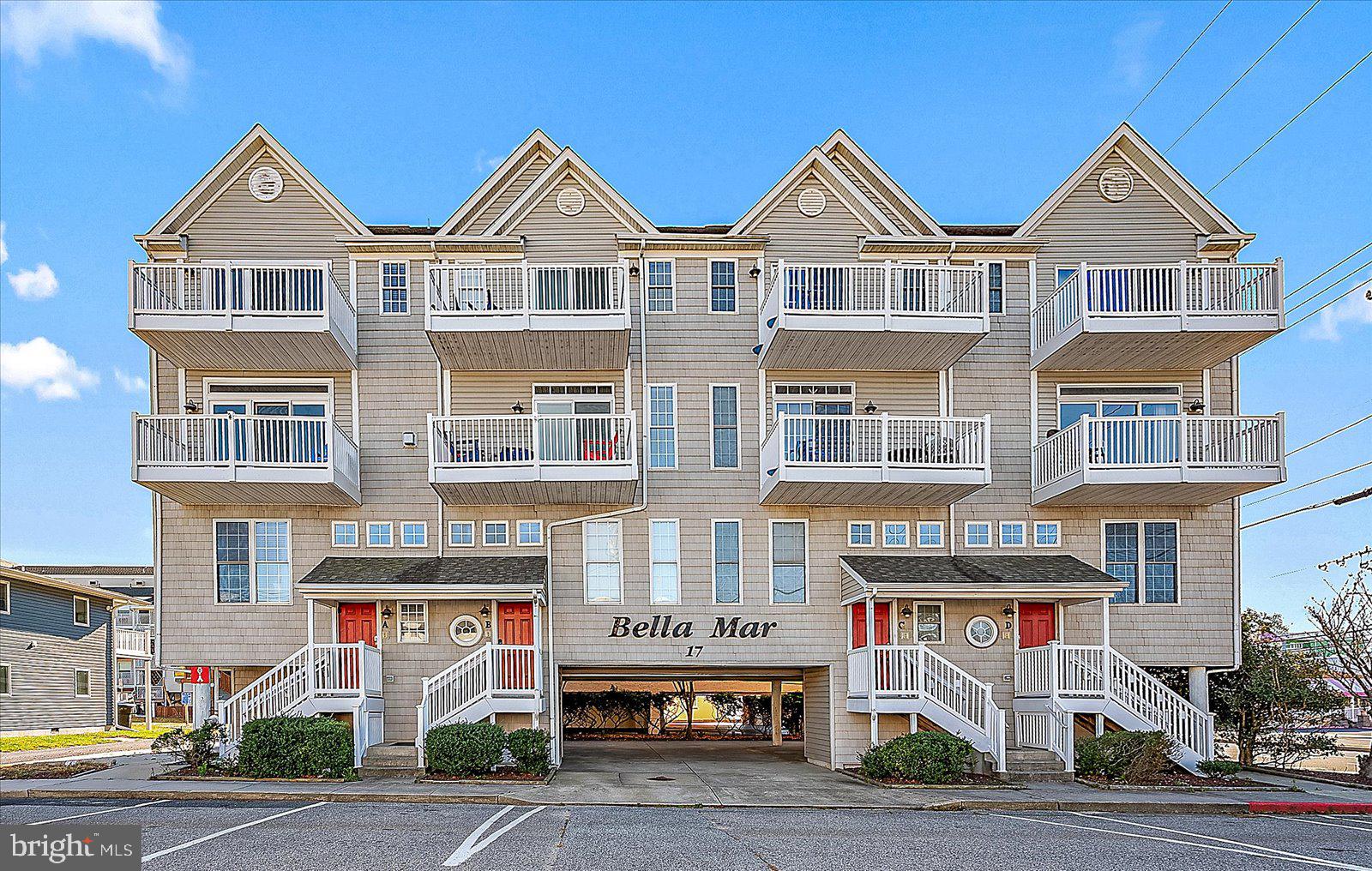 Just one block from the beach, this bright and airy 4-bedroom, 3-bath townhome showcases sweeping ocean and bay views from nearly every room. The open floor plan is a great space for entertaining, featuring a spacious living room with wood-like laminate flooring, walls of windows, and slider doors leading to your large private deck with wonderful views of both the ocean and the bay. A cozy fireplace completes this inviting space.  The expansive kitchen boasts abundant cabinetry and extensive granite counters, seamlessly flowing into the dining area—perfect for hosting family and friends. Each generously sized bedroom is filled with windows and natural light, offering comfort and privacy for every guest.  Enjoy coastal breezes from any of the four private decks, including the top-floor master suite’s deck with panoramic sunrise-to-sunset views.  The master bedroom features vaulted ceilings and an elegant en-suite with a tiled walk-in shower.   A massive ground-floor storage closet for all your beach gear helps keep your home neat and clean, plus two private parking spots (one covered), and plentiful street parking.  Situated in prime mid-town Ocean City, close to dining, shopping, and easy access to both the Boardwalk and North OC, this home offers incredible rental potential (over $40k in 2024) or the perfect beach retreat for making memories year-round.