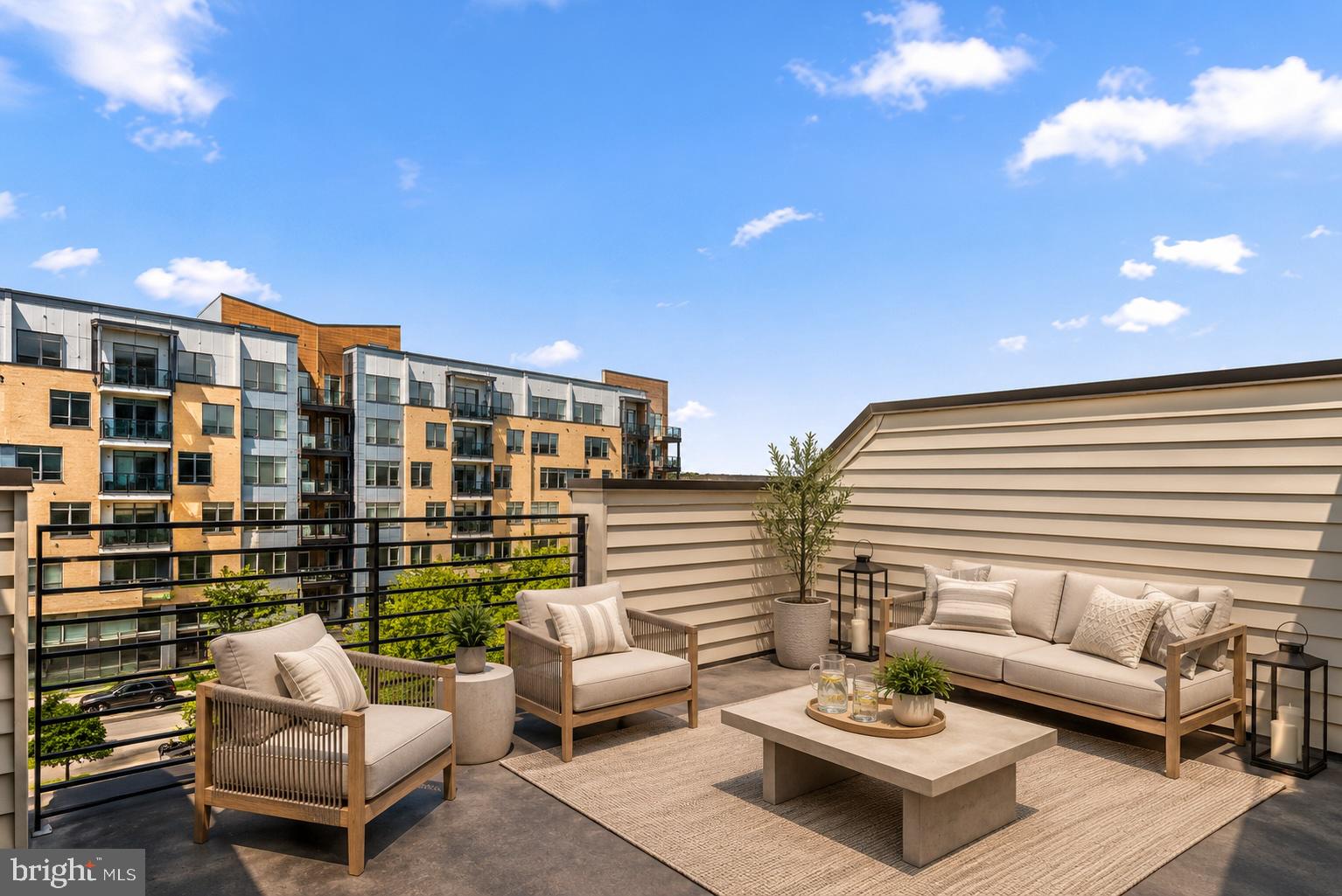 Nestled within a courtyard, away from the main roads, this 2019 luxury townhome spans four levels of beautifully designed living space, a private rooftop terrace, and secure garage parking.

Enter through the ground-level foyer, currently configured as a home office, complete with a convenient half bath. Upstairs, the sun-filled main level features an airy open-concept layout anchored by a sleek modern kitchen with upgraded cabinetry, quartz counters, stainless appliances, and a center island with storage and breakfast bar seating. The adjoining dining area flows seamlessly into the living room, where wide-plank hardwood floors and abundant natural light create a sophisticated yet inviting atmosphere. An additional half bath completes this level. 

The next level offers two generously sized bedrooms, each with its own ensuite bath. On the top floor, you'll find a third bedroom, full bath, and a versatile flex space ideal for a lounge, home gym, office, or guest retreat. Step outside to the private rooftop terrace — the perfect setting for morning coffee, sunset cocktails, or entertaining under the stars.

Park your in the garage because you won’t need it in this unbeatable Rockville location. Everything you need is just outside your doorstep! TWO blocks from Twinbrook Metro and THREE from the new Wegmans! Easy access to Rockville Pike, Rockville Town Square, Pike & Rose, Bethesda, DC and all of the shopping, dining and everyday conveniences your heart desires.