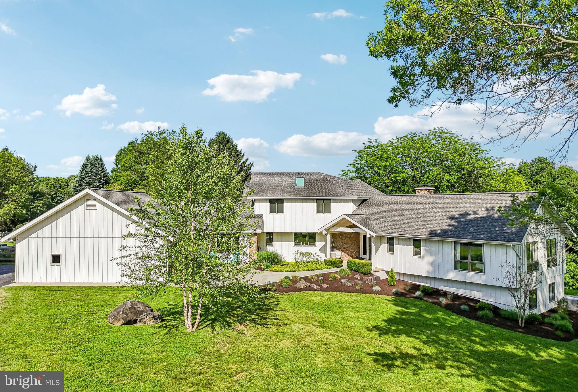 Welcome to 989 Delchester Road Newtown Square in Willistown Township and Great Valley School District. This stunning 5 bedroom, 5 bathroom home sits on 4 breathtaking acres offering amazing views whether inside or out. The bright interior offers plenty of windows and glass doors especially on the rear of home allowing constant sunlight to stream in. Hardwood floors grace the first floor and extend into a cozy family room with vaulted ceiling, stone fireplace, and doors to the expansive composite deck. The updated kitchen with white shaker cabinetry, island seating, and granite counters exits to the covered porch that overlooks the impressive yard. The left side of the home which once was an in-law suite, offers a pantry/laundry room, an additional living room with fireplace, full bathroom, one bedroom, and a bonus room used as a study. Off of this space is a sunroom that takes you to the mudroom and two car garage. This level is completed with an ensuite bedroom with updated bathroom with double sink vanity and shower, 2 bedrooms, and a hall bathroom. The second level offers a spacious primary suite with a large walk-in closet, luxurious bathroom, and private deck. The lower level is finished with a fireplace and exits to the exterior. The fenced yard is not to be missed offering a salt water pool with plenty of deck space for relaxing and tons of flat area for play and sports and an outdoor shower. This amazing Radnor Hunt property is close to all major roadways for an easy commute and minutes to a variety of shopping and dining options in Malvern, Ellis Preserve and West Chester. Call today for more information; this property is not to be missed!