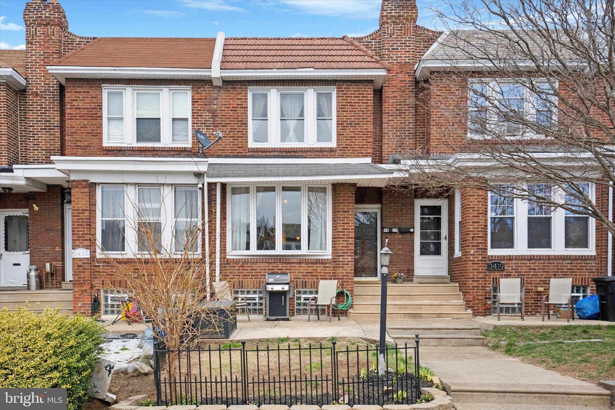 Welcome to 3417 Shelmire Avenue! This well-maintained Mayfair home offers an abundance of space, storage, and natural light. Set off the street, this home has a front yard and patio for grilling with neighbors and friends. Enter into the vestibule area with space for coats and shoes which lets out into a large living room. The first floor features many charming original details like hardwood floors with walnut inlay, original stair banister, decorative brick fireplace, and original trim. The spacious living room leads you into the formal dining room- with two corner storage closets!- and then to the rear kitchen. Storage is not an issue in this house because there are plenty of cabinets, open shelving, and a pot rack to store your kitchen items, as well as a pantry tucked away in the stairwell entrance to the basement. The kitchen also has a nook in the corner which could be used for a table or sitting area. Downstairs, you'll find a finished basement with a powder room and large family room with a bar. At the rear of the basement is a garage/storage room. The garage door has been closed in because the owners use this for storage, however it could easily be converted back into a working garage.  This is accessed via a rear alleyway between the rows of houses and you can park an additional car in front of the door. The primary suite is on the second floor in the front with a large triple window that lets in plenty of natural light, two closets, and an en suite bathroom with tub.  Fun fact- there is also a laundry chute that goes to the basement! There is another full bathroom with a shower that is accessed via the hallway for the additional two bedrooms, which are both spacious and bright.  This home is located just two blocks from Lincoln High School and Propel Academy, as well as Mayfair Playground and Lincoln Pool, and there is easy access to shopping, public transportation, and major highways. Here you can get the best of both worlds- it's just a short drive to Center City to experience everything Philadelphia has to offer and you can also enjoy nature by taking a short walk to Pennypack Park, with its beautiful creek and walking trails.