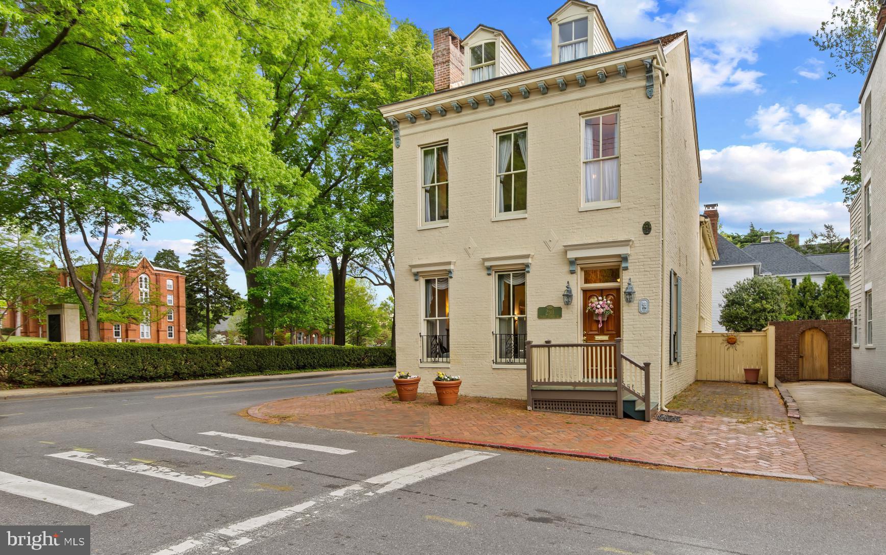 Perfectly positioned in the heart of downtown Annapolis, this distinguished historic residence offers a rare opportunity to own a piece of the city’s architectural legacy while enjoying the convenience of two coveted off-street parking spaces. Overlooking the beautifully preserved grounds of St. John’s College, the home captures timeless views that enhance its already exceptional setting.

Steeped in history, the property reflects an evolution of craftsmanship spanning centuries, with the original portion dating to the mid 1800s, an expansion in the late 1800s, and a thoughtfully integrated addition in 1921. Sold fully furnished, the interiors are curated with elegant period pieces that complement the home’s character and provide a seamless, move-in-ready experience. Enjoy peace of mind with the updated electrical and plumbing  in 1990 , new hot water heater in January of 2024, new shake shingle roof in April 2026 and 2 new heat pumps in March 2025

Inside, classic architectural details unfold across the main level, where two gracious parlors—each anchored by a fireplace—offer inviting spaces for both intimate gatherings and relaxed everyday living. A welcoming entry hall with an open staircase sets the tone, leading to a charming dining room with its own fireplace and a convenient pass-through to the kitchen, blending historic ambiance with functional flow.

The upper levels provide flexibility and space, with four bedrooms and two full baths on the second floor, while an additional bedroom occupies the top level—ideal for guests, a private retreat, or creative workspace. Below, the basement offers practical utility space and storage.

Just moments from the shops, restaurants, and waterfront attractions of downtown, as well as the United States Naval Academy, this residence invites you to fully immerse yourself in the vibrant Annapolis lifestyle. From morning walks along tree-lined streets to evenings enjoying the energy of the harbor, this is a home where history, location, and livability converge in a truly special way. Welcome Home!