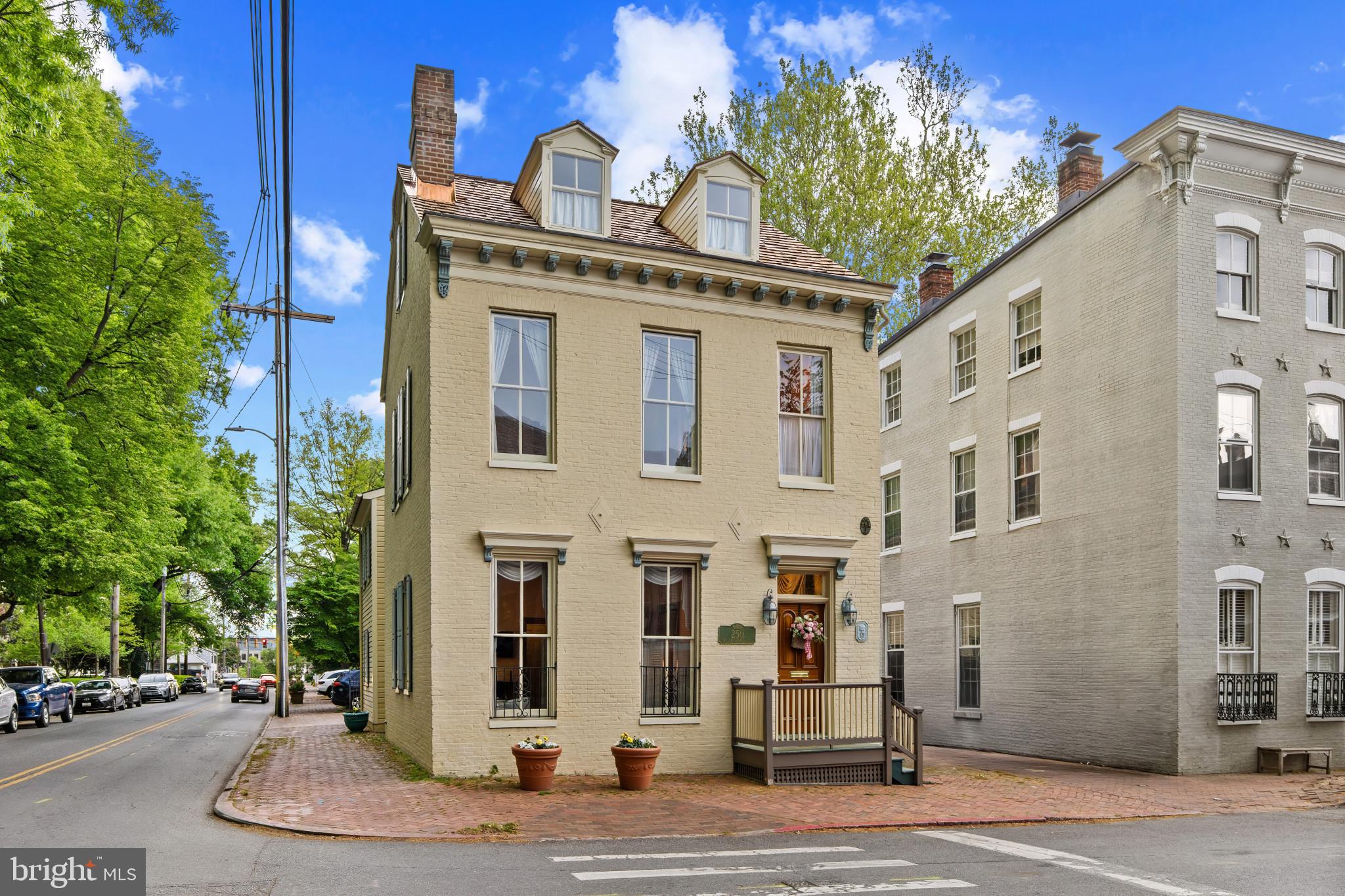 Perfectly positioned in the heart of downtown Annapolis, this distinguished historic residence offers a rare opportunity to own a piece of the city’s architectural legacy while enjoying the convenience of two coveted off-street parking spaces. Overlooking the beautifully preserved grounds of St. John’s College, the home captures timeless views that enhance its already exceptional setting.

Steeped in history, the property reflects an evolution of craftsmanship spanning centuries, with the original portion dating to the mid 1800s, an expansion in the late 1800s, and a thoughtfully integrated addition in 1921. Sold fully furnished, the interiors are curated with elegant period pieces that complement the home’s character and provide a seamless, move-in-ready experience. Enjoy peace of mind with the updated electrical and plumbing  in 1990 , new hot water heater in January of 2024, new shake shingle roof in April 2026 and 2 new heat pumps in March 2025

Inside, classic architectural details unfold across the main level, where two gracious parlors—each anchored by a fireplace—offer inviting spaces for both intimate gatherings and relaxed everyday living. A welcoming entry hall with an open staircase sets the tone, leading to a charming dining room with its own fireplace and a convenient pass-through to the kitchen, blending historic ambiance with functional flow.

The upper levels provide flexibility and space, with four bedrooms and two full baths on the second floor, while an additional bedroom occupies the top level—ideal for guests, a private retreat, or creative workspace. Below, the basement offers practical utility space and storage.

Just moments from the shops, restaurants, and waterfront attractions of downtown, as well as the United States Naval Academy, this residence invites you to fully immerse yourself in the vibrant Annapolis lifestyle. From morning walks along tree-lined streets to evenings enjoying the energy of the harbor, this is a home where history, location, and livability converge in a truly special way. Welcome Home!