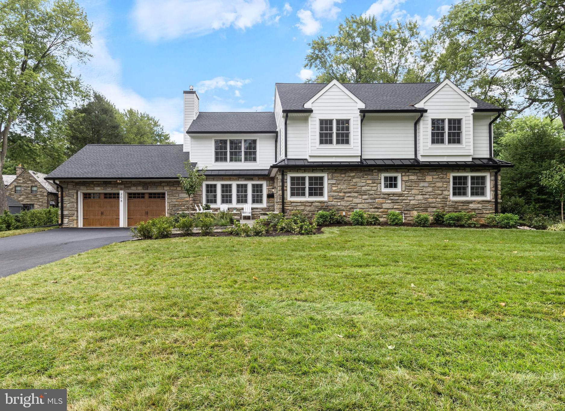 208 Sycamore Lane is a stunningly renovated residence located in the most coveted
neighborhood in Wallingford, Lapedia Hills. This elegant home retains it’s original charm
and solid foundation, but has been completely updated and expanded, offering 5
bedrooms, 3.5 bathrooms, and almost 5,000 square feet of brand-new living space.
Upon entering, you'll be warmly greeted with well-appointed, plush, high-end finishes
that emanate a sense of sophistication and luxury. A masterpiece of craftsmanship, this
home is also perfectly situated on a large, level lot with sweeping views of the
Springhaven Country Club golf course.
The interior boasts an open and smart floor plan, seamlessly integrating the bright and
airy living spaces with thoughtful design and maintenance-free living. The large gourmet
kitchen is a chef's dream, featuring top-of-the-line appliances, custom cabinetry,
exquisite quartz countertops, an expansive island with ample seating for 6, a wet bar
and multiple beverage fridges. The Anderson sliding door leads to the gorgeous
Bluestone patio, with golf course views, it’s the perfect place for impressive entertaining
as well as everyday enjoyment of the glorious landscaping and sweeping yard. The
lavish landscaping incorporates evergreens, flowering plants and native specimens, all
of which will thrive with the newly-installed irrigation system. The living room is accented
with a beautiful custom gas fireplace with custom mantel and trim work and large Anderson windows, overlooking the charming bluestone front Patio, a wonderful spot to welcome neighbors. The first floor is
complete with a large home office/den (which could also serve as a 6th bedroom), and
an additional bonus room that offers the flexibility of a wonderful first-floor primary
bedroom with a beautiful en-suite bathroom with walk-in shower. There is a spacious
powder room for your guests, a coat closet, and a well-configured mudroom with plenty of
custom storage cubbies. Conveniently, the mudroom connects the attached two-car
garage to the home and offers additional access to the rear yard.
The generous second-floor primary bedroom is breathtaking and features soaring tray
ceilings, oversized windows with eye-catching views, a large walk-in closet, and a huge
bonus/storage room, offering endless options as an additional closet, small office or
craft space. The primary en-suite bathroom is stunning and features a large walk-in
shower with Moen fixtures (found throughout) and exquisite tile work. There are three
additional, large bedrooms on the second floor which share a beautiful hall bathroom,
two of the front bedrooms feature custom window seats and all bedrooms have ample
closet space and are TV-ready with wall outlets and blocking. The second
floor is complete with a well-placed Laundry/Utility room, which is washer/dryer ready,
adding to the exceptional ease of living found throughout this home. The lower level
offers endless possibilities as an open playroom or additional family room with billiards
and pool table, or limitless options to add an additional office, bedroom and bathroom.

In addition to the home's remarkable features and unparalleled location adjacent to the
Springhaven Country Club, it is located in the heart of the award-winning Wallingford-
Swarthmore School District, adding to the appeal of this exceptional property. New roof,
with gutter system and leaf guards, new Anderson windows, new HVAC, new
appliances, new driveway, new landscaping and irrigation system, new outdoor patios,
garage doors…too much new to mention everything! Please come see this home for
yourself, and don’t miss the opportunity to experience the epitome of elegance and
smart design in this exquisite, turn-key home. Schedule your private tour and make 208
Sycamore Lane your forever residence.