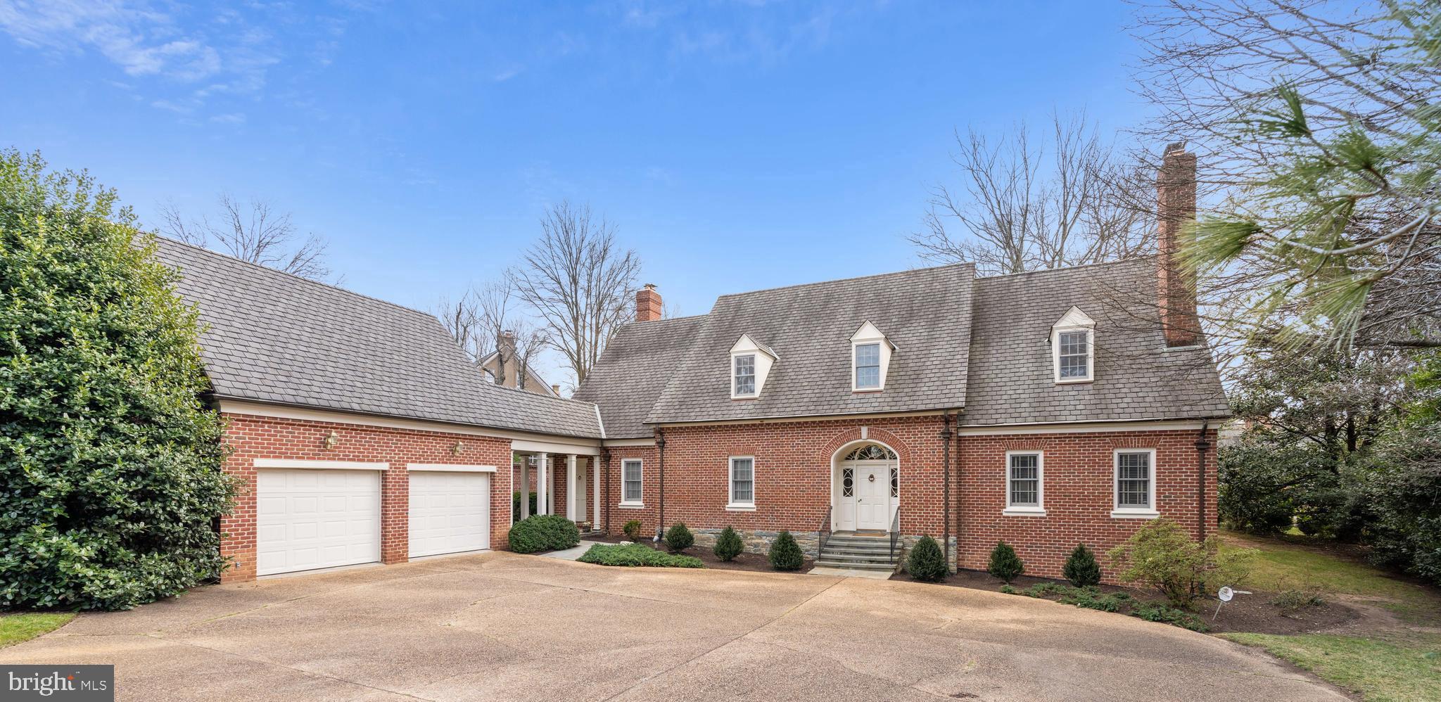 Custom designed and built, gorgeous Williamsburg colonial style home on a secluded private lot across from the Seminary.   Featuring a grand entry, formal living room with deep crown  and chair rail moldings and a  gas fireplace with designer mantel translate into a  gracious and impressive home, crafted with meticulous attention to detail and craftsmanship. The living room fireplace reclaimed  mantel is flanked by built in bookcases and cabinets. On the wall opposite the fireplace are a wet bar and office nook hidden behind hinged doors, which blend in beautifully with the custom millwork in this elegant room.  The dining room is generous enough to host large gatherings and offers custom lighted china cabinets on either side of the stately arch into the entry, as well as deep crown and  chair rail moldings.Recessed into this arch between the dining room and the foyer, is a set of pocket doors built on a grand scale for an owners convenience. The dining room flows seamlessly into the kitchen and opens to the rear gardens,  patios and dining pavilion under a beautiful pergola through a gorgeous French door. 
     Off the living room is a back hall leading to a main level PRIMARY BEDROOM, full bath, walk-in closet, second hall closet and china closet. The Primary Suite can be easily closed off from the main living areas of the house by closing two doors. The main level primary bedroom can also be utilized as a large library, with a French door opening to the slate patios, dining pavilion under the pergola and rear garden.   Off the dining room is a very spacious kitchen with center island and seating, with a massive pot rack to showcase a gourmet chef's selection of pots and pans. The kitchen is open to the family room with a gas fireplace flanked by built-in bookcases and cabinets as well as a separate breakfast room and solarium. The family room can be accessed through a back hall from the breezeway leading to the two-car garage. In addition to built-ins in the back hall, there is a powder room, pantry and owner's office opening to the kitchen and family room.   
     The upper level offers three additional bedrooms and two baths. The larger bedroom or secondary PRIMARY SUITE on this level offers a private sitting room or upstairs family room, walk-in closet and owner’s bath. There is a door in the primary bedroom leading to an enormous space off the bedroom which offers storage, or, potentially, a private office, exercise room or artist’s studio.  This hidden "attic" space offers unlimited possibilities for one to create a private retreat within the Primary Suite. 
      The lower level offers grand space for children’s activities or an inventor's workshop, while still providing a great deal of storage as well as space for a relaxing game of pool or table tennis. The recreation room offers a gas fireplace and an ideal space to watch TV, play games and just relax. This space has a rough in bath and could, potentially, be reimagined into a lower level bedroom and living area. The oversized "Junk Room" and secondary storage rooms are ideal for off season decorations and clothes.  
     To complete this very special home, there is a replica of a Williamsburg style out building intended to be a gardener's workshop or shed. With a new roof, it is ready to greet a new owner with built in shelves and counters. The extensive gardens in the back of the house are backlit by exterior lighting and augmented by two wall fountains. All of the exterior lighting and the fountains are in working order but not guaranteed. 
The grounds have been professionally designed and meticulously maintained over the years and offer an inground irrigation system to assist with maintaining them year round.