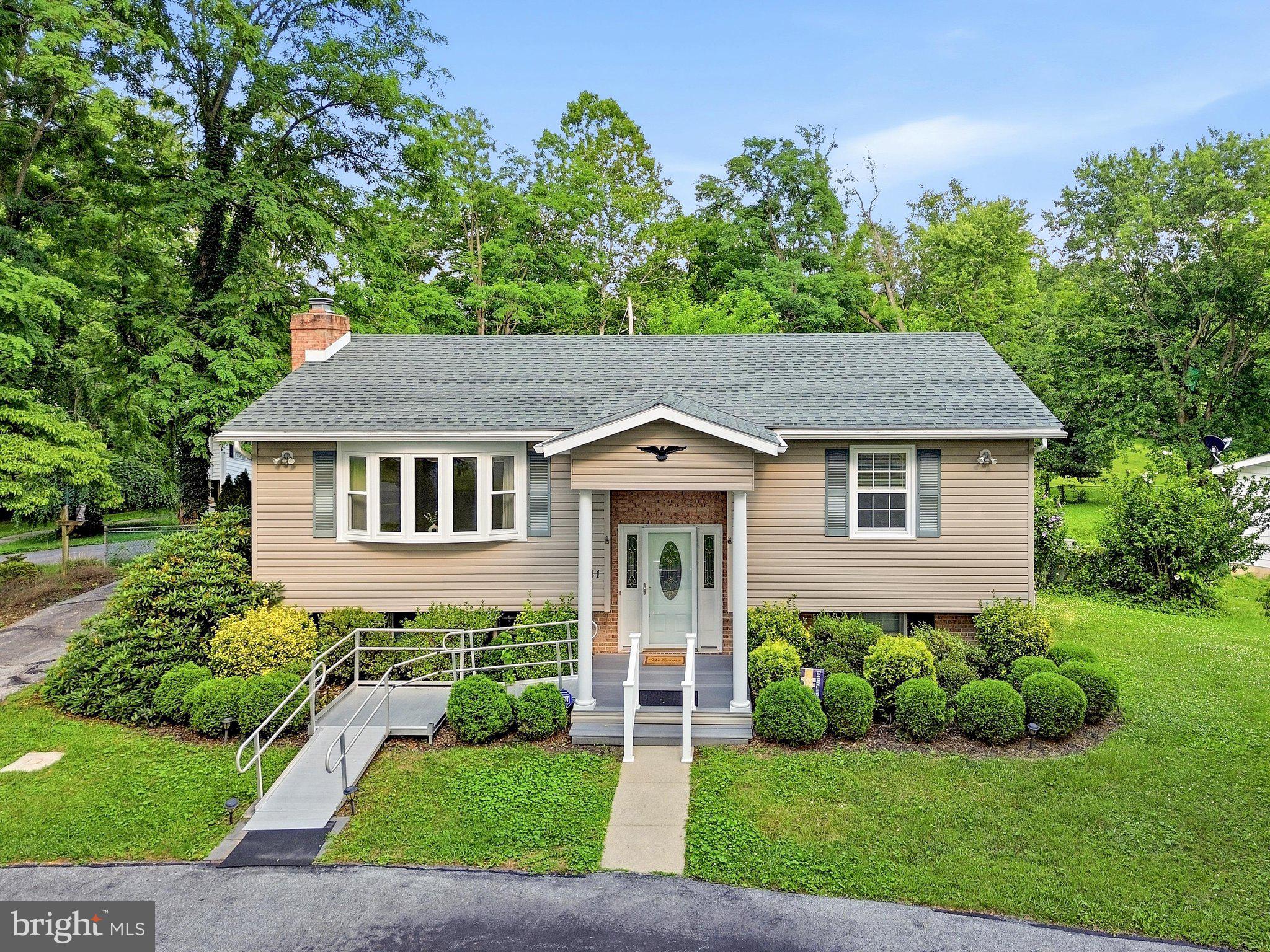 Nestled in an established neighborhood shaded by mature trees, this charming split-level home offers 2 bedrooms, 2 full baths, and the potential to easily create a third bedroom with minimal finishing in an already framed lower-level space. The main level features a comfortable living room, two bedrooms, a full bath, and a bright kitchen and dining area designed for everyday living. The gleaming wood floors add to the classic feel. Step outside to a spacious deck overlooking the fenced backyard, complete with a storage shed for tools and outdoor equipment. The walkout lower level expands your living space with a cozy family room featuring a fireplace, a full bath with a jetted tub/shower combination, and a laundry area adjoining a partially finished room that could serve as a third bedroom, home office, hobby room, or additional storage. A stair chair lift is already in place and can convey with the home or be removed at the buyer's request, making this home a flexible option for a variety of lifestyles.